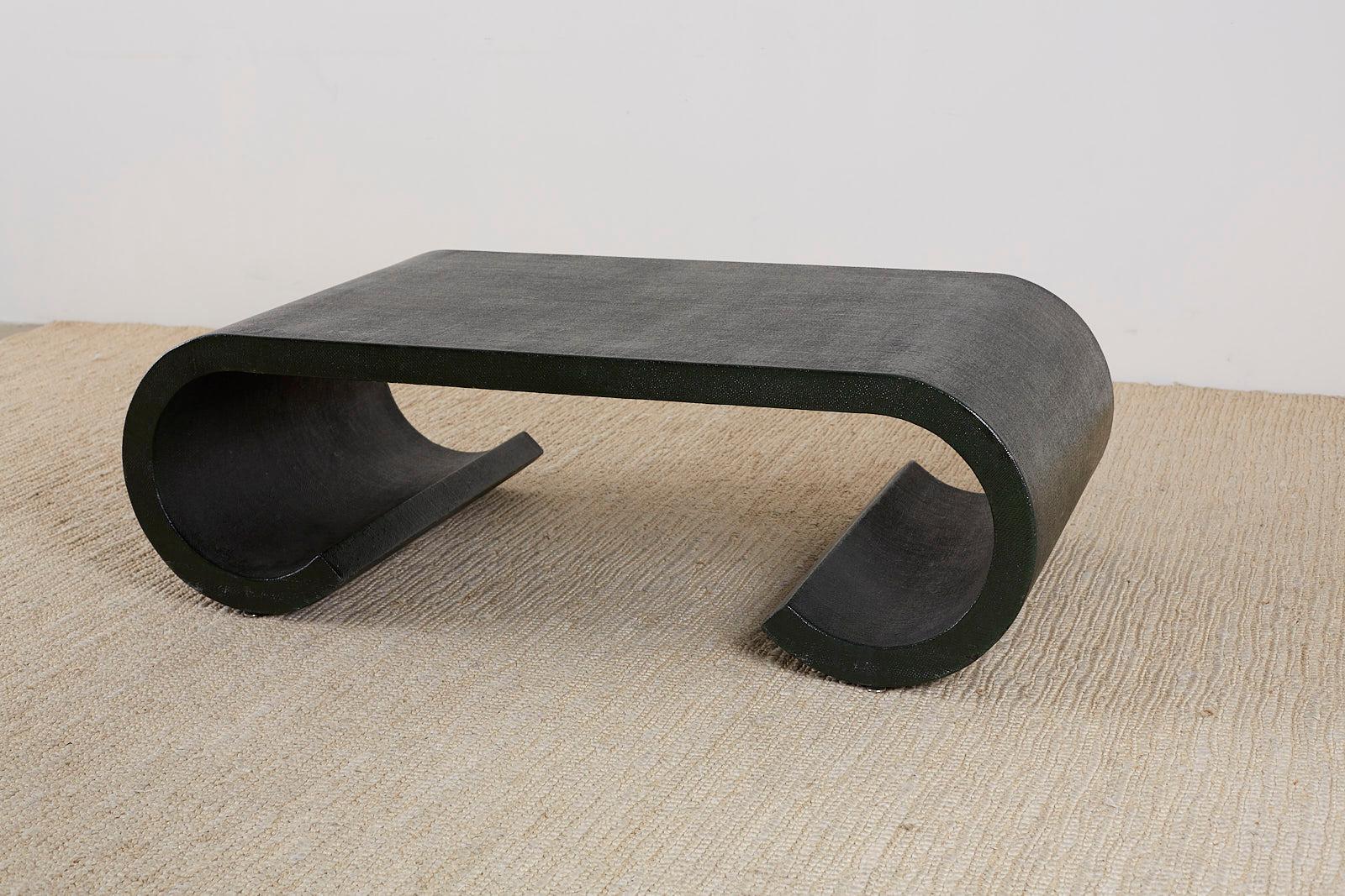 Fantastic lacquered scroll coffee table or cocktail table featuring an organic raffia or grasscloth wrap. Made in the Hollywood Regency style and manner of Karl Springer. The entire table is wrapped and lacquered in a deep hunter green glossy finish
