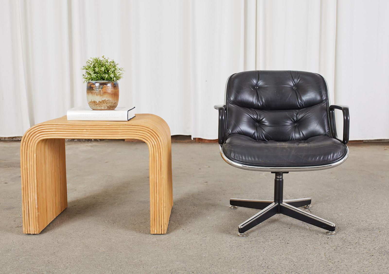 Mid-Century Modern drinks table or side table featuring a pencil reed rattan veneer finish. The table is unmarked, however it is made in the organic modern style and manner of Karl Springer and Jean-Michael Frank. Finished on all sides and inside