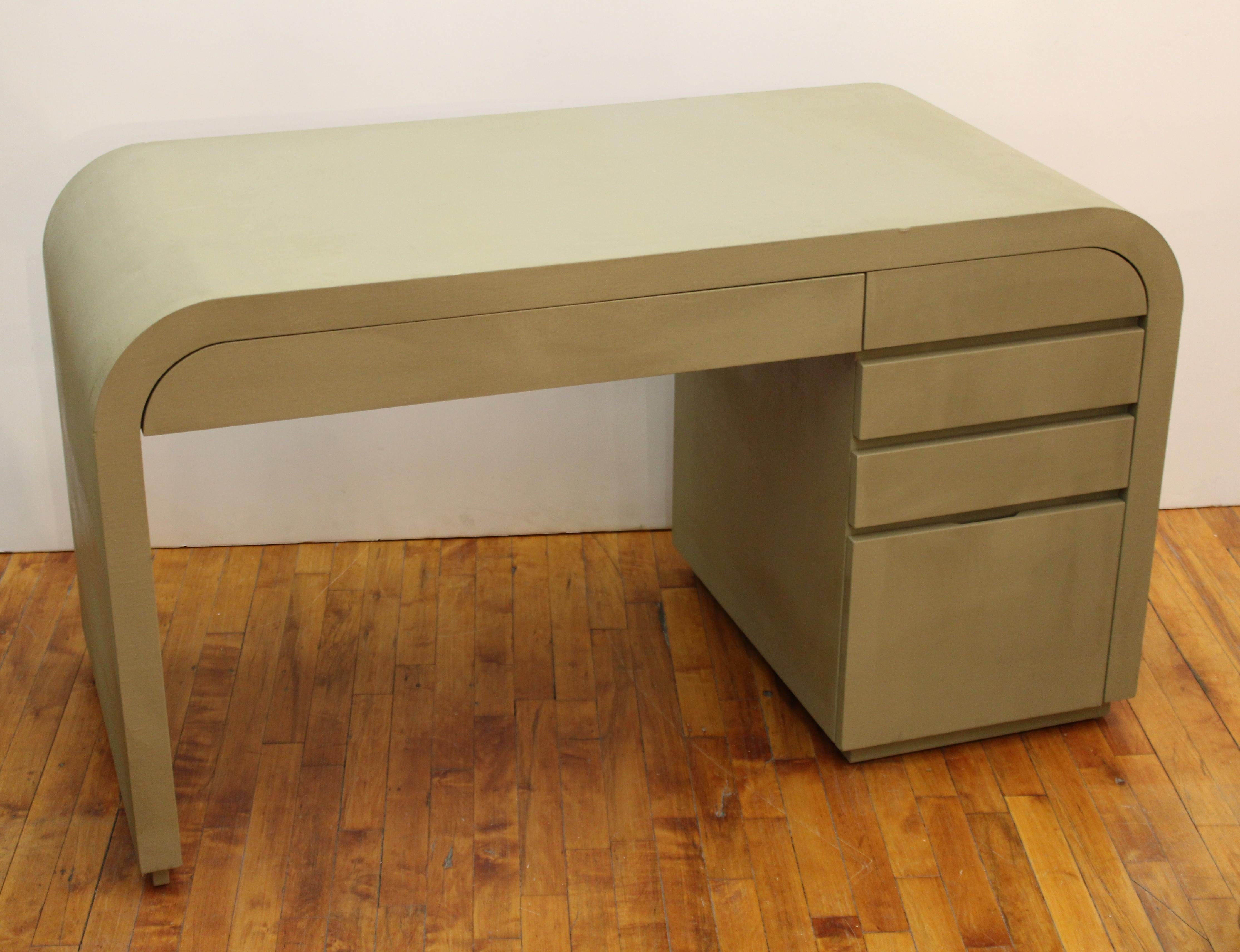 Postmodern work desk with grass-cloth surface, in the style of Karl Springer. The desk is designed in an Art Deco revival style and features waterfall edges on the sides. In great vintage condition with age-appropriate wear and use.