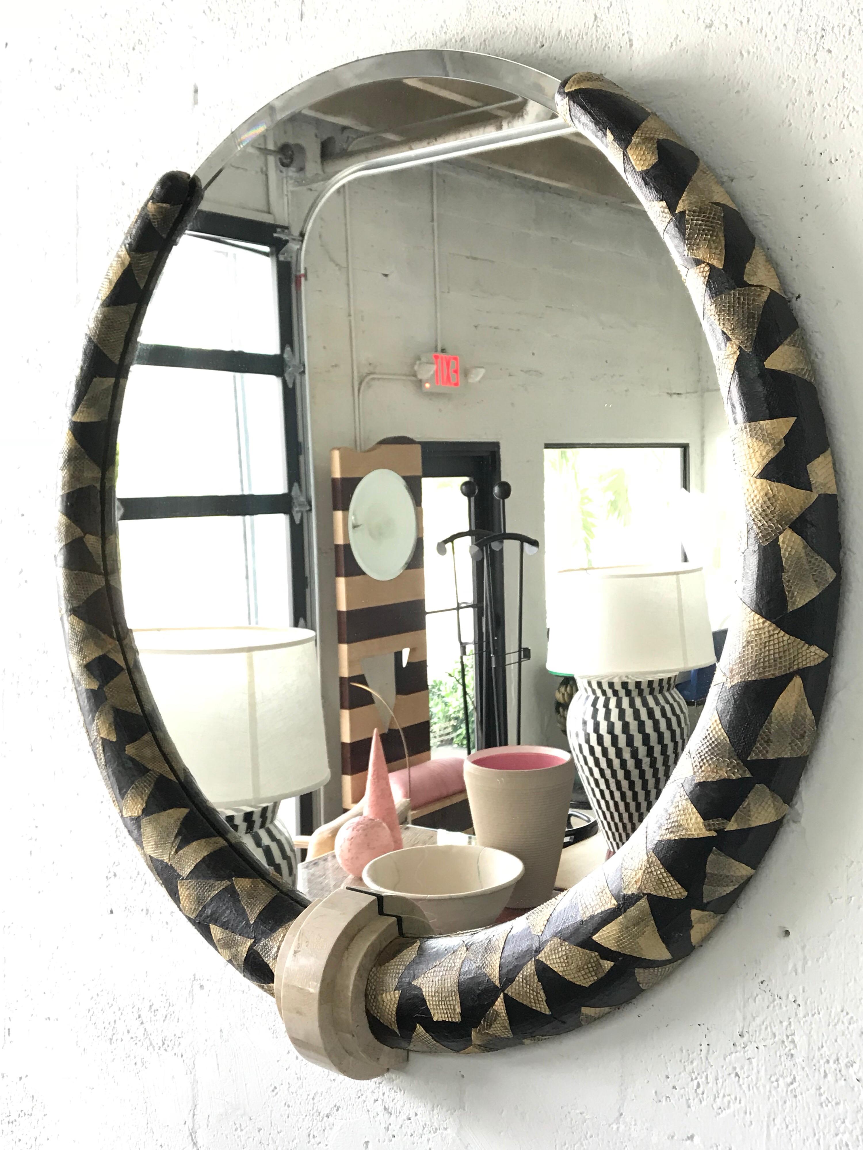 Art Deco Renaissance mirror with a tribal motif rendered in patchwork black and white python snake skin and tessellated stone in the manner of Karl Springer.
