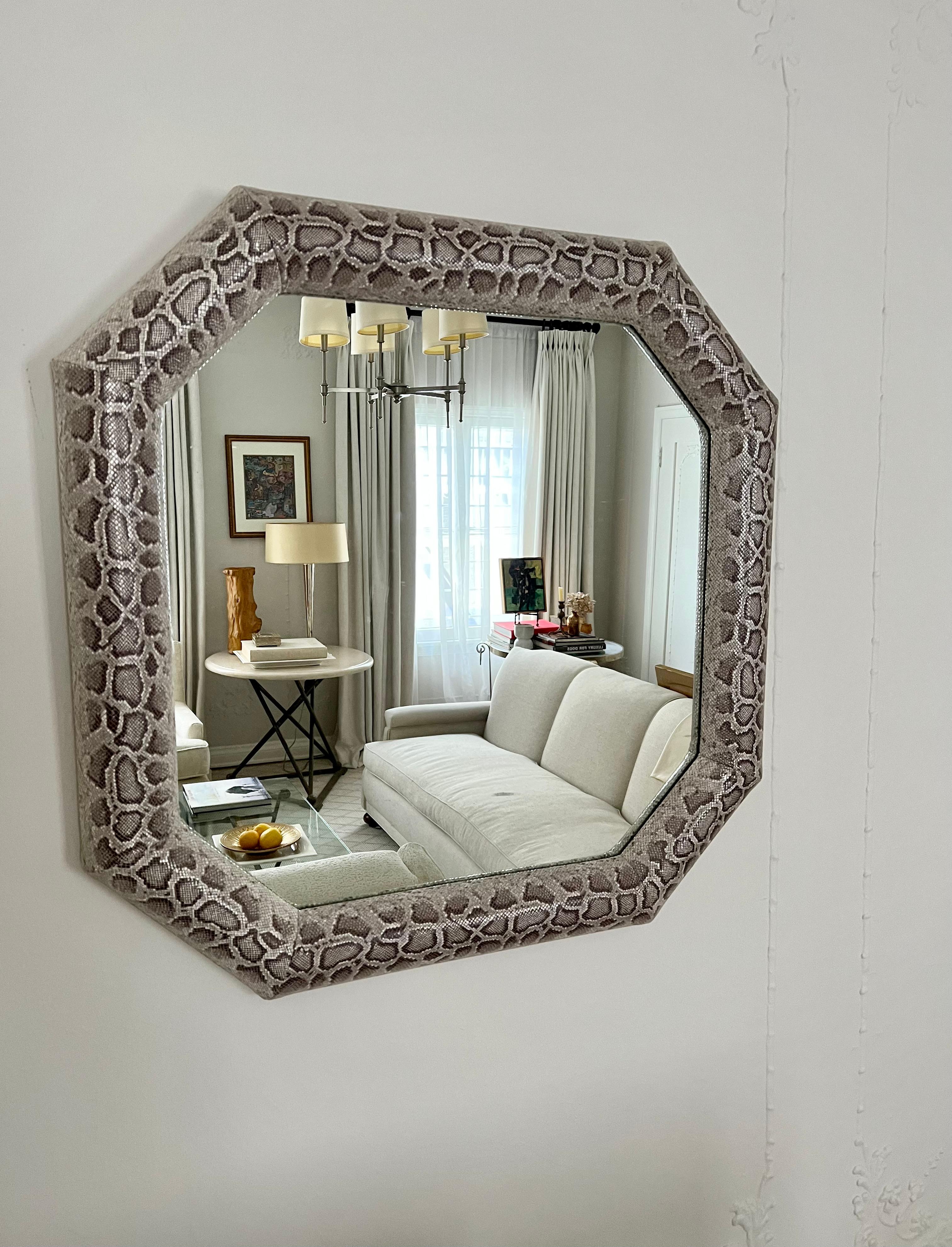 Python upholstery covers this wall mirror. A lovely piece representing the period with a wonderful and dynamic snake upholstery. The piece has been completely restored and has a great feeling in person. the leather has the same feel and energy of