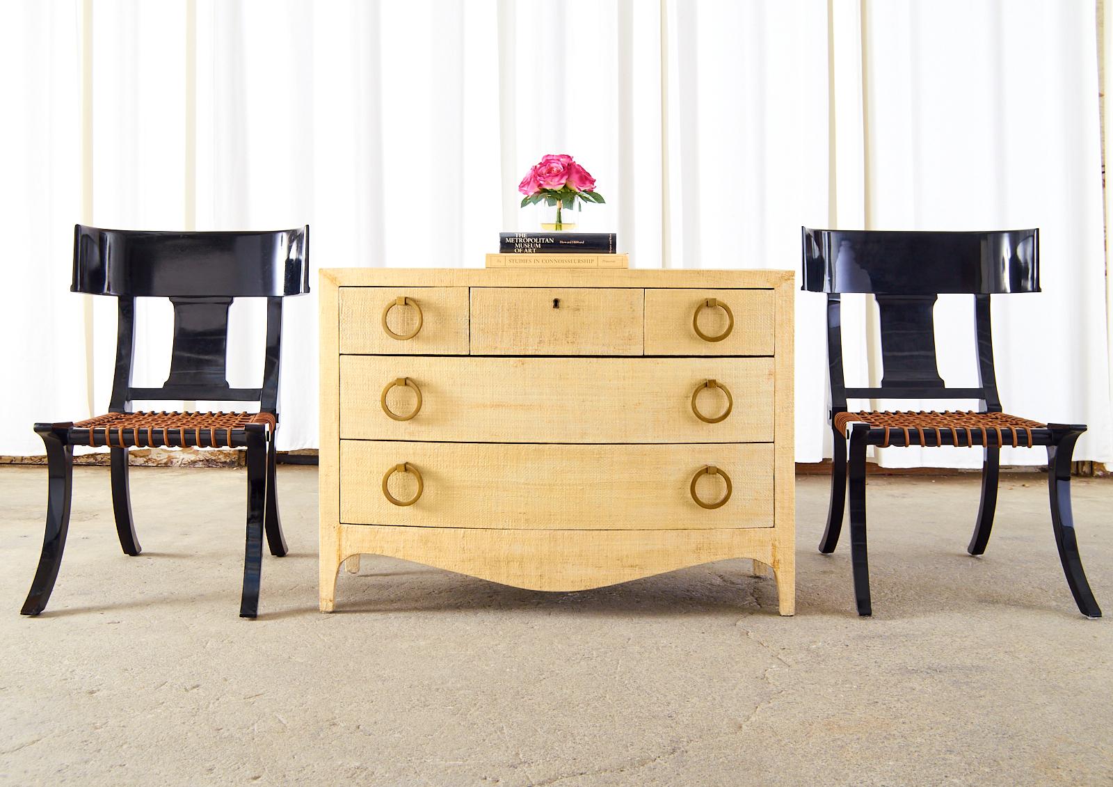Opulent commode, dresser, or chest of drawers featuring a handsome organic modern raffia grasscloth wrapped or clad case. Made in the fabulous style and manner of Karl Springer. Crafted from radiant grained mahogany the chest has six drawers fitted