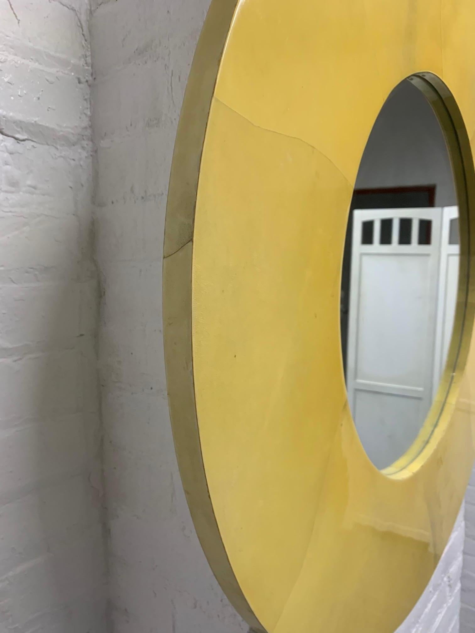 Round lacquered goatskin mirror in the style of Karl Springer.