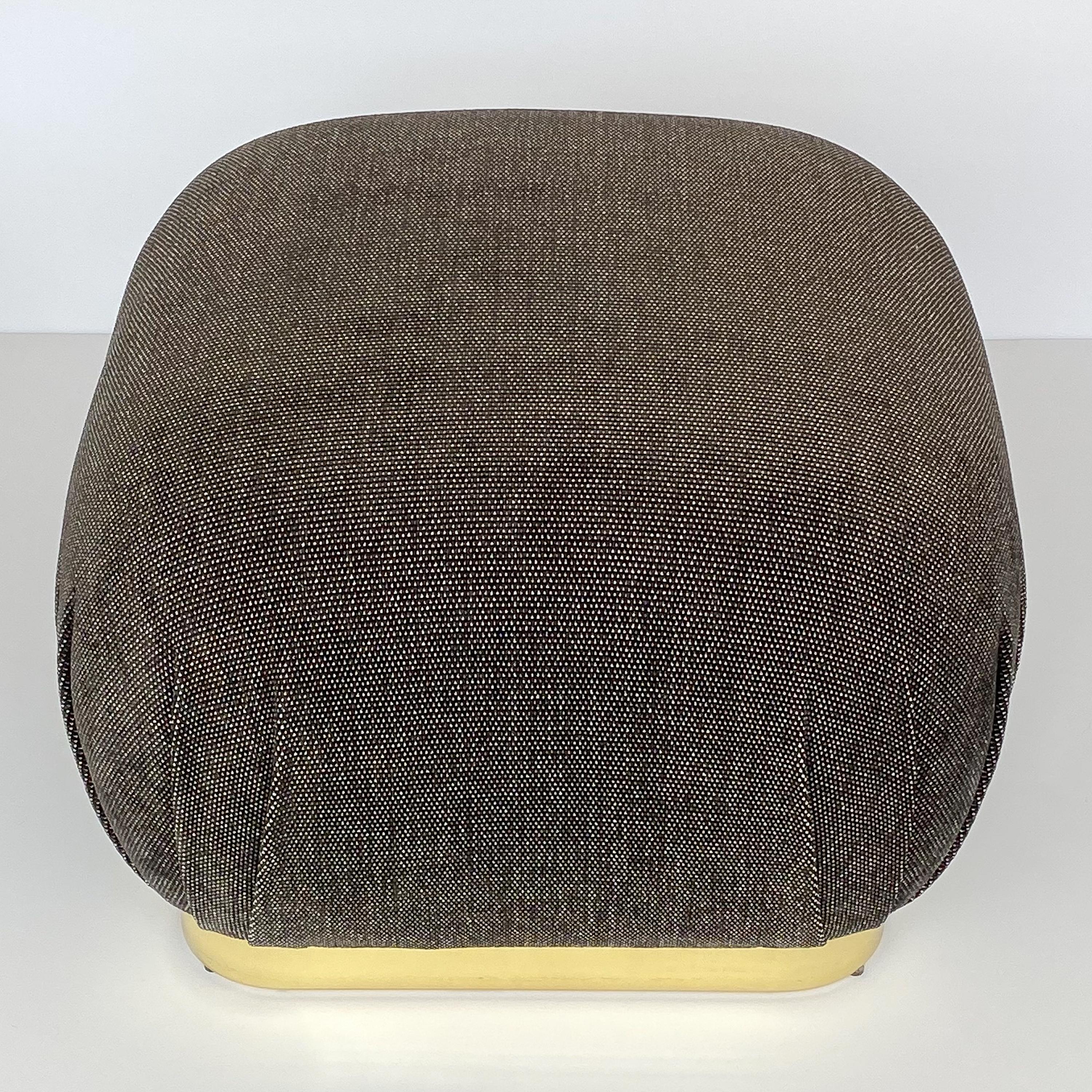 A Karl Springer style brass soufflé pouf ottoman, circa 1970s. This ottoman has been newly upholstered in a viscose blend chenille fabric in a warm gunmetal gray and white dot. New foam throughout. 2