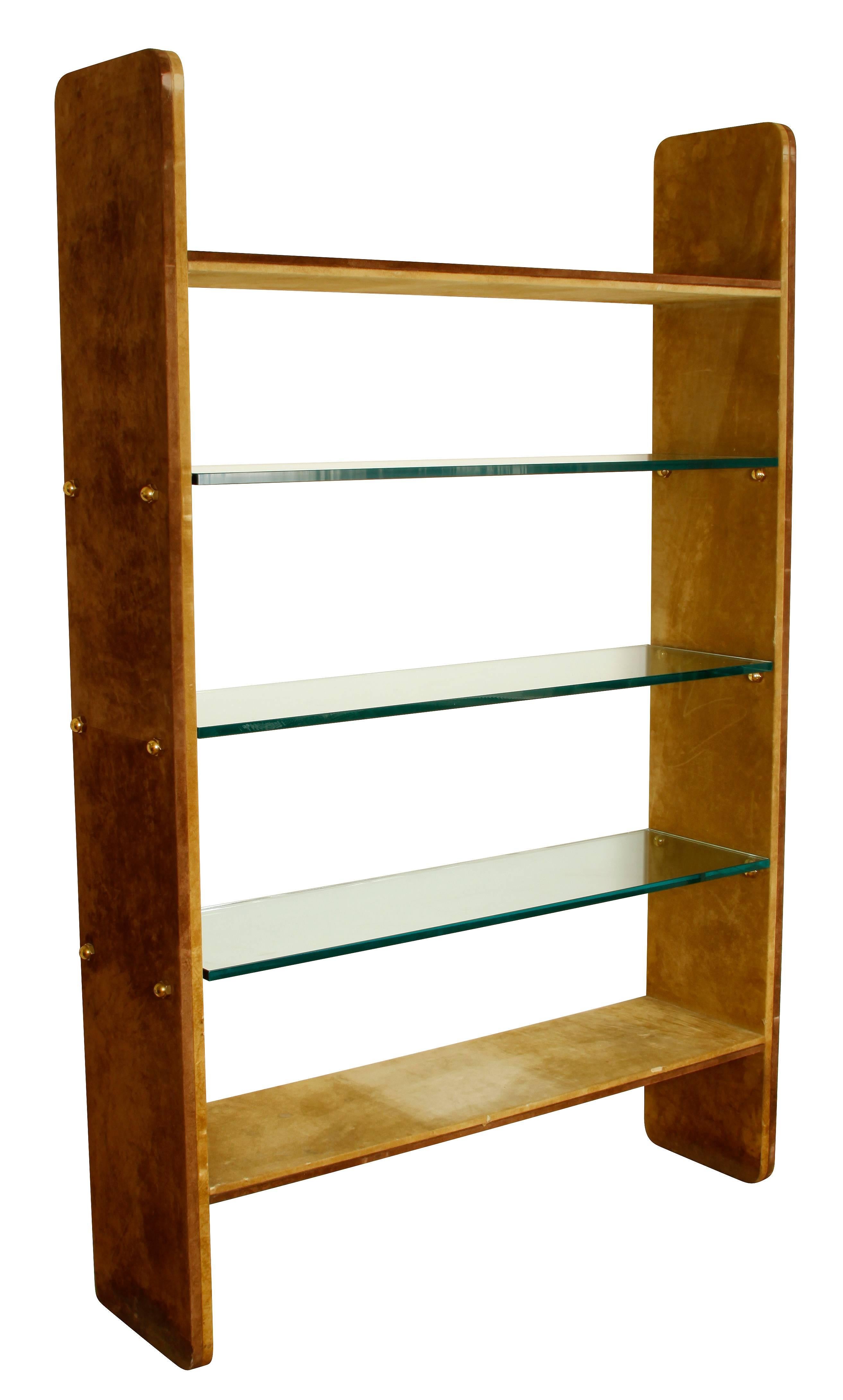 Karl Springer style two-tone suede and glass etagere. Five shelves, two in suede and three in heavy glass, with brass bolt supports.