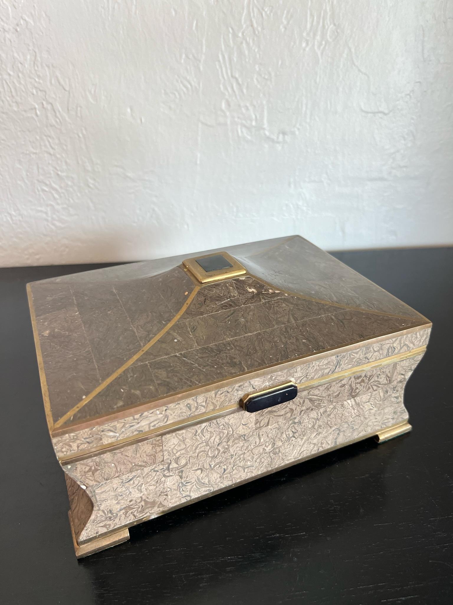 Karl Springer style tessellated stone and brass box. Mahogany lined interior with compartment for storage. Beautiful patina to the brass accents. 

Would work well in a variety of interiors such as modern, mid century modern, Hollywood regency,