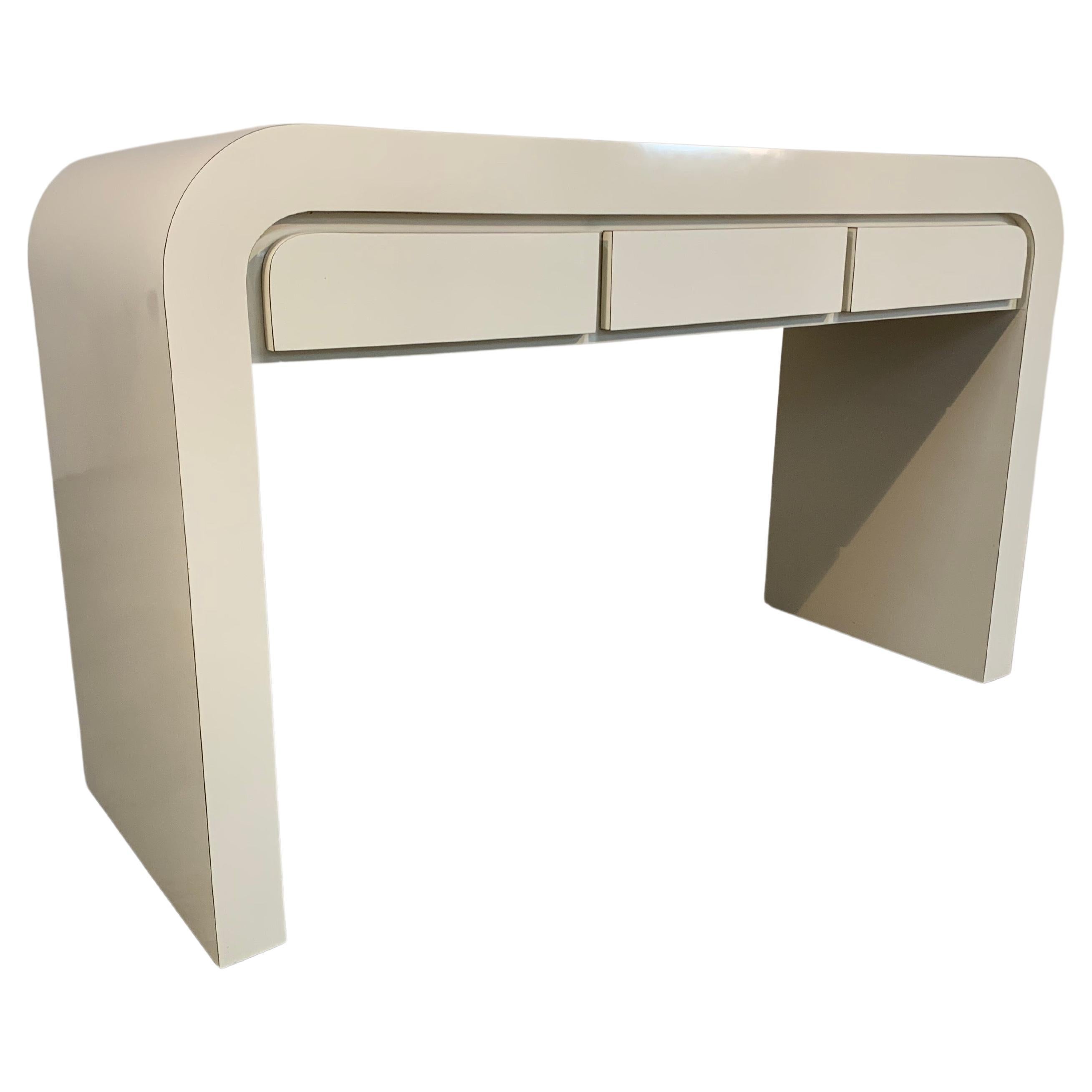 A post modern 1980’s waterfall desk in the manner of Karl Springer having 3 storage drawers. 
 In fabulous condition. Clean and ready for use!