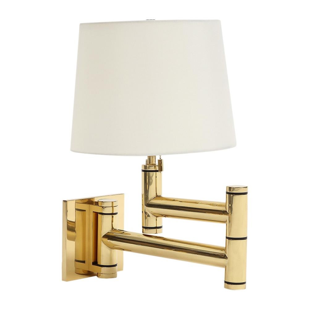 Karl Springer Swing Arm Wall Lamps, Polished Brass. Pair of heavy swing arm wall lamps with super quality build and Springer's signature coffin pull chains. Meticulously restored by Empire Metal of Astoria. Lamps have been re-plated in lacquered