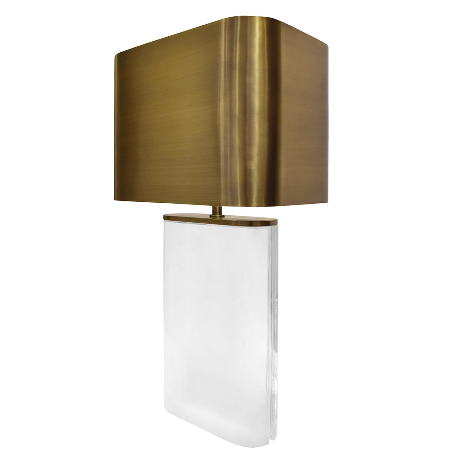Large solid Lucite table lamp with bronze hardware and shade by Karl Springer, American 1970s. The cord is embedded into the curved side of this lamp so it is not visible from the front. Springer had metal artisans fabricate seamlessly welded metal