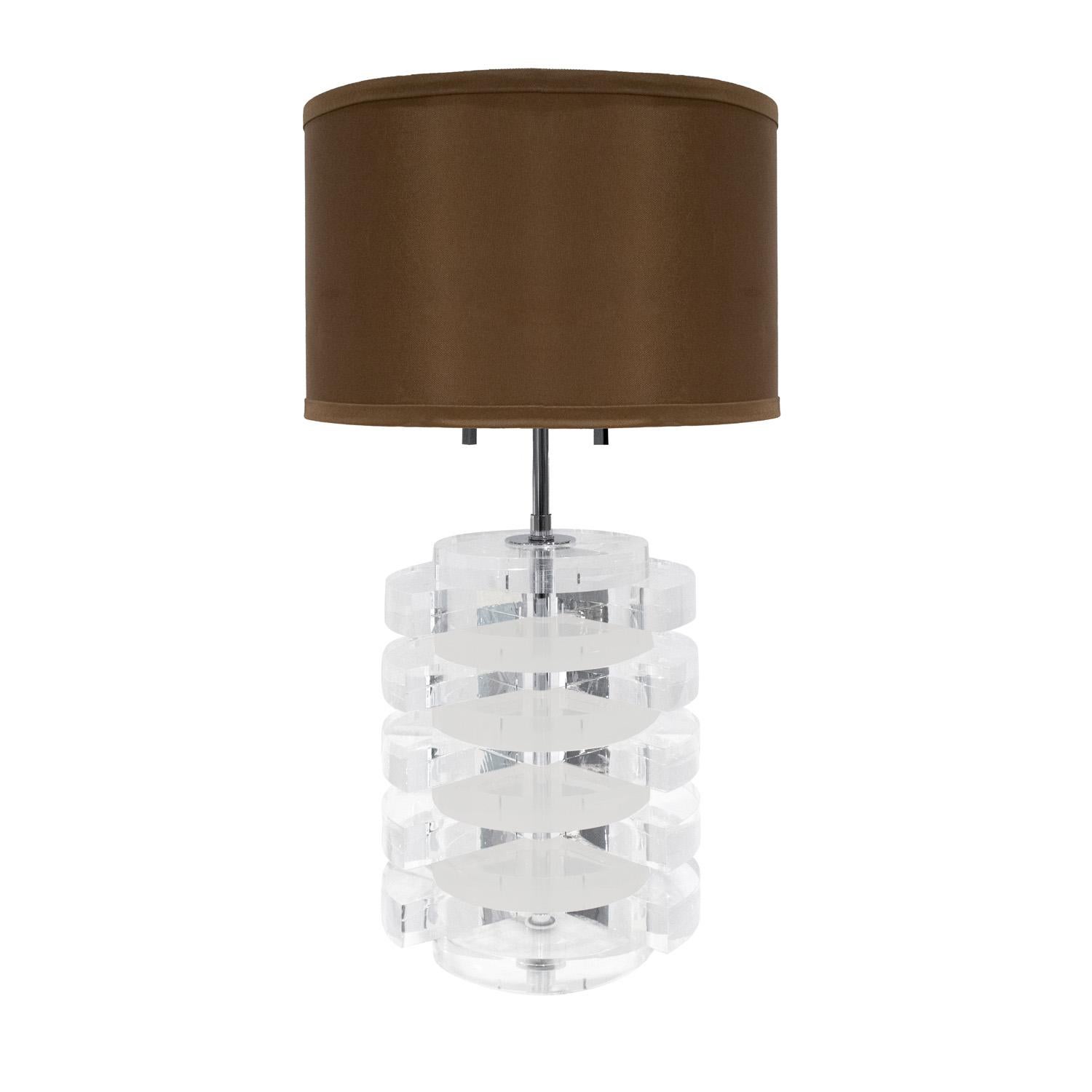 Table lamp with solid lucite discs and polished chrome hardware by Karl Springer, American 1970's. The stacked lucite disks are very chic.  Newly rewired with new sockets and cord.

Dimensions:
Diam: 9 inches
H: 26 inches (adjusts to 29