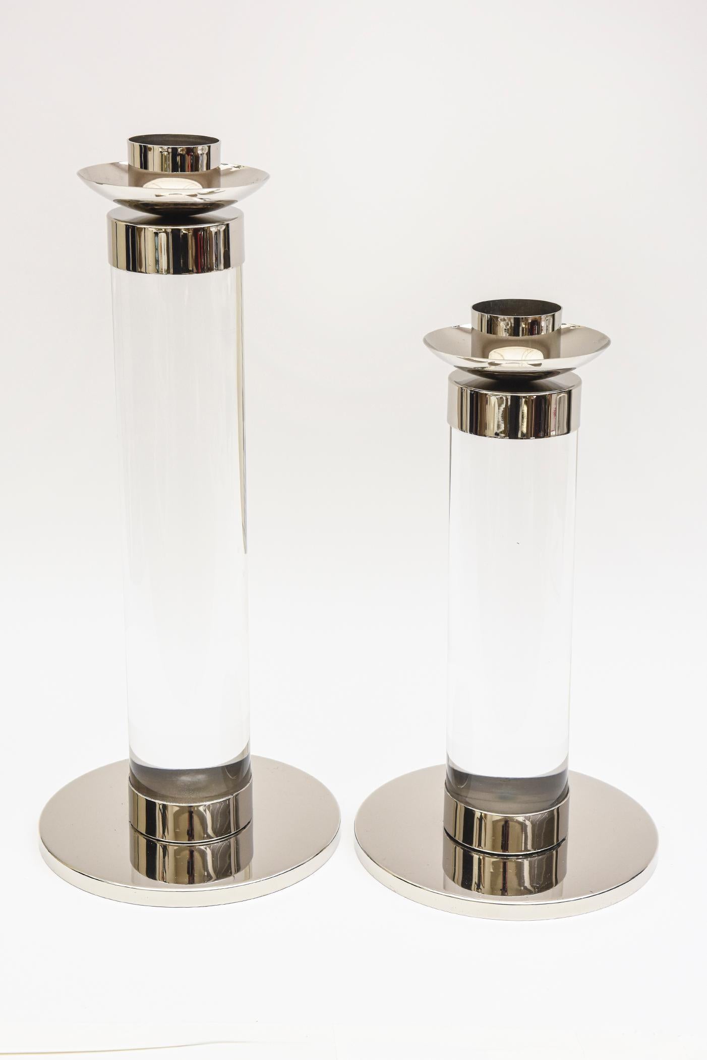 This pair of chic chunky thick Karl Springer style lucite and chrome column candlesticks are monumental. They are 2 different heights. The larger one is 18.5