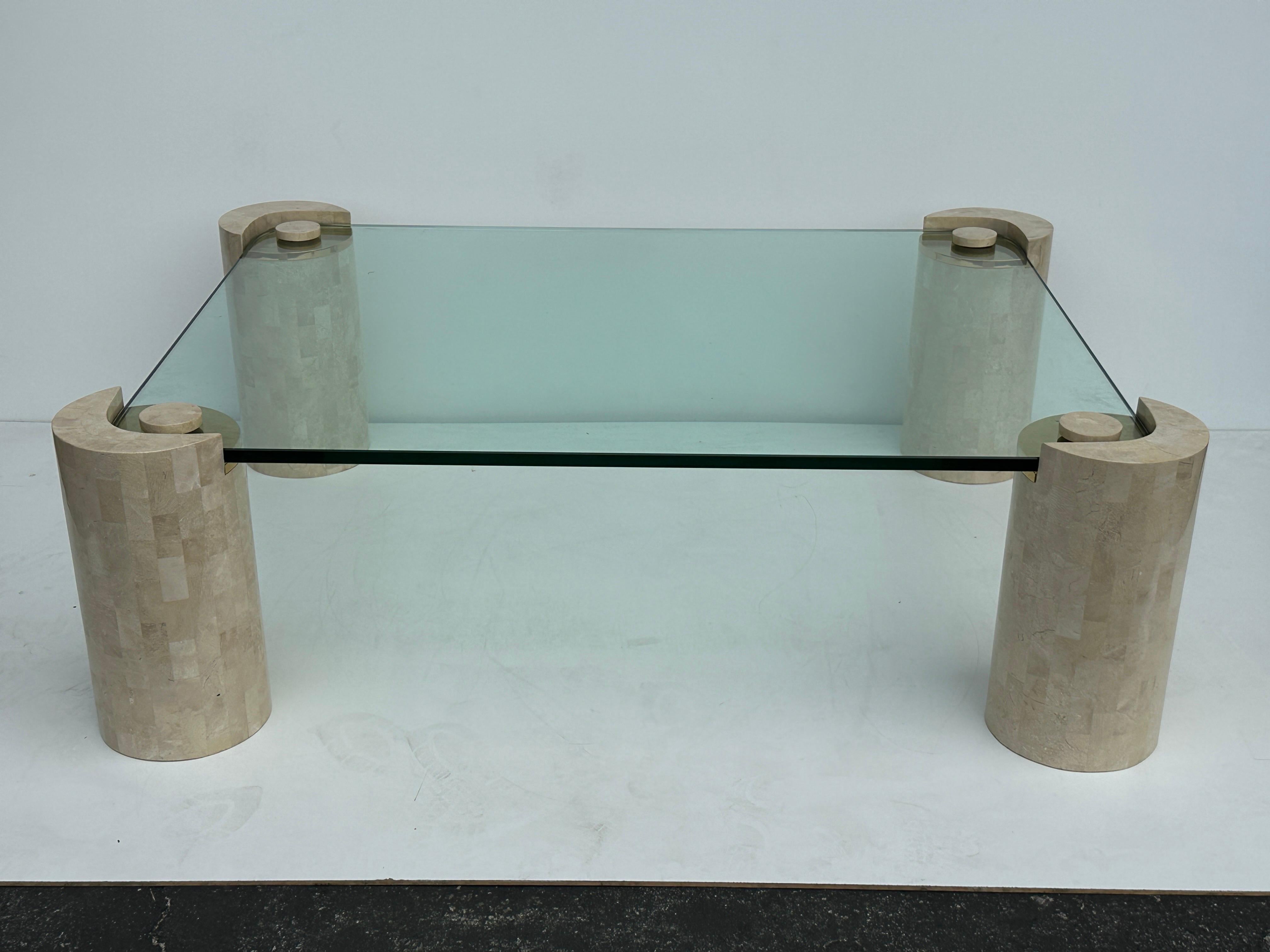Karl Springer tessellated fossil coral and brass coffee table. Each leg measures 8” diameter by 16.25” high. Only glass top is 3/4” thick, 48” wide and 36” deep. Overall measurements are 52” x 40”x 16.25