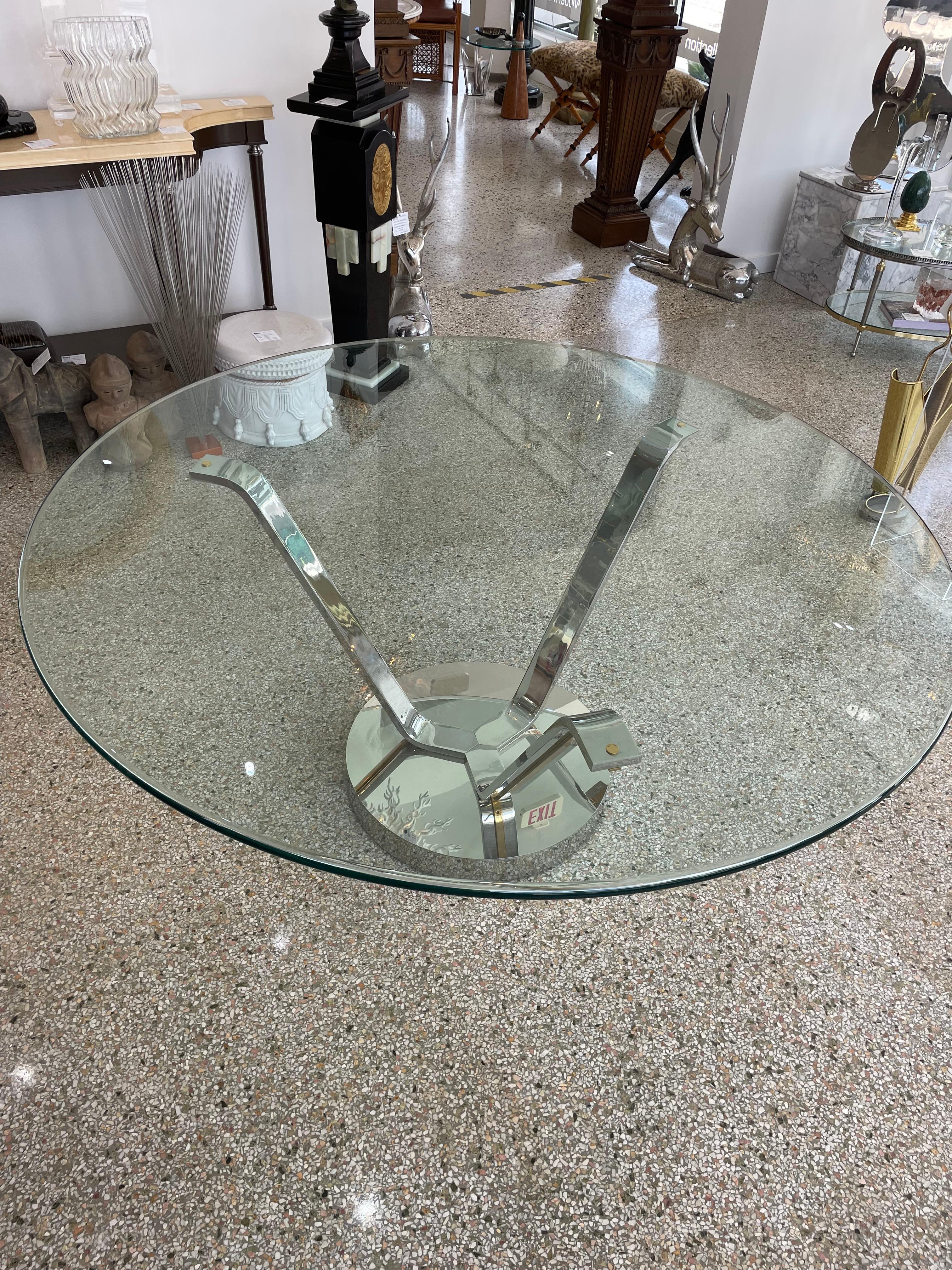 This stylish and dramatic dining table dates to the 1980s and was created by the iconinc German Amreican designer Karl Springer. The table is known as the 