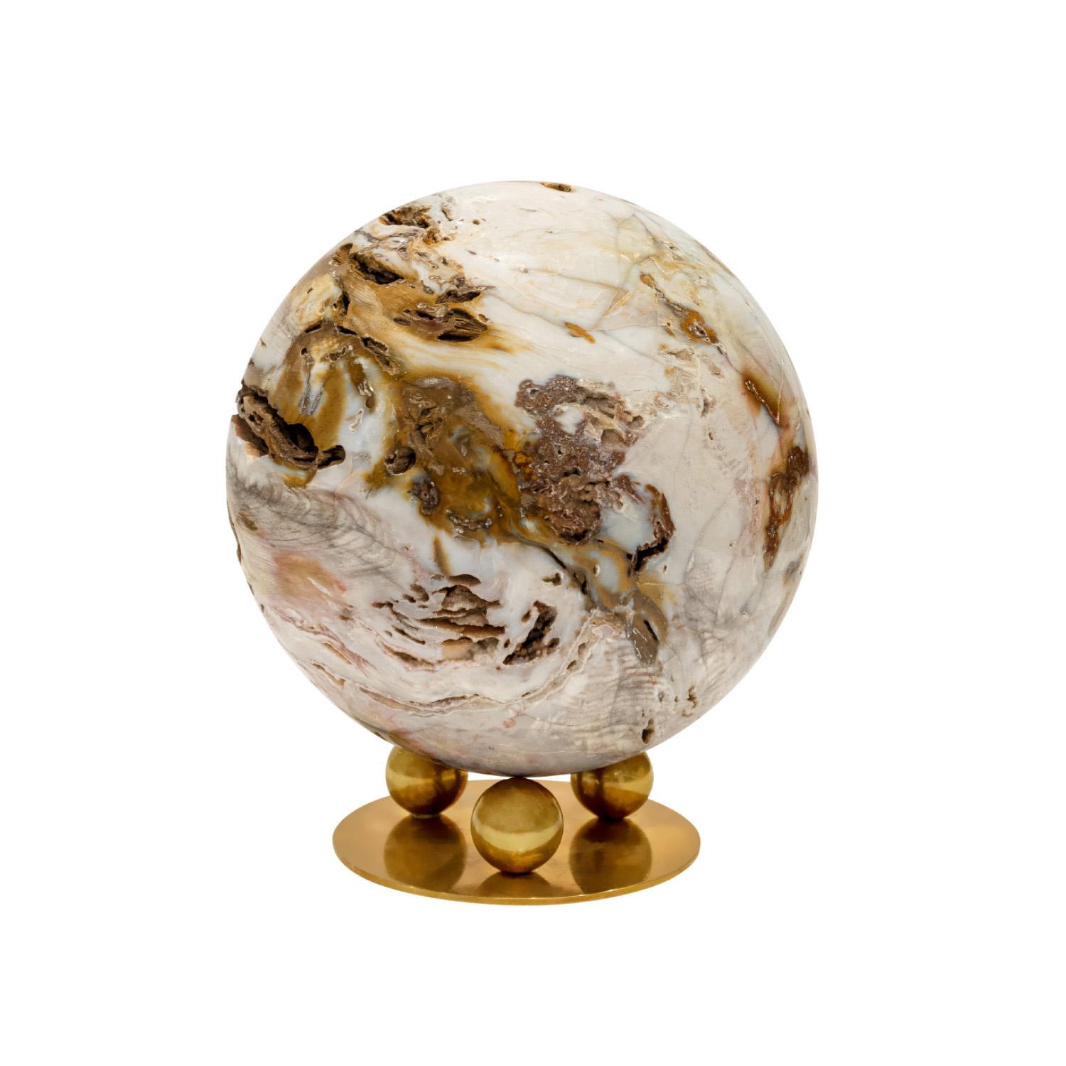 Remarkable unique large polished petrified wood orb on custom brass base by Karl Springer, American 1980s. Exotic materials and superb craftsmanship were the hallmark’s of Karl Springer’s design ethos. Because the petrified wood was organic, it has
