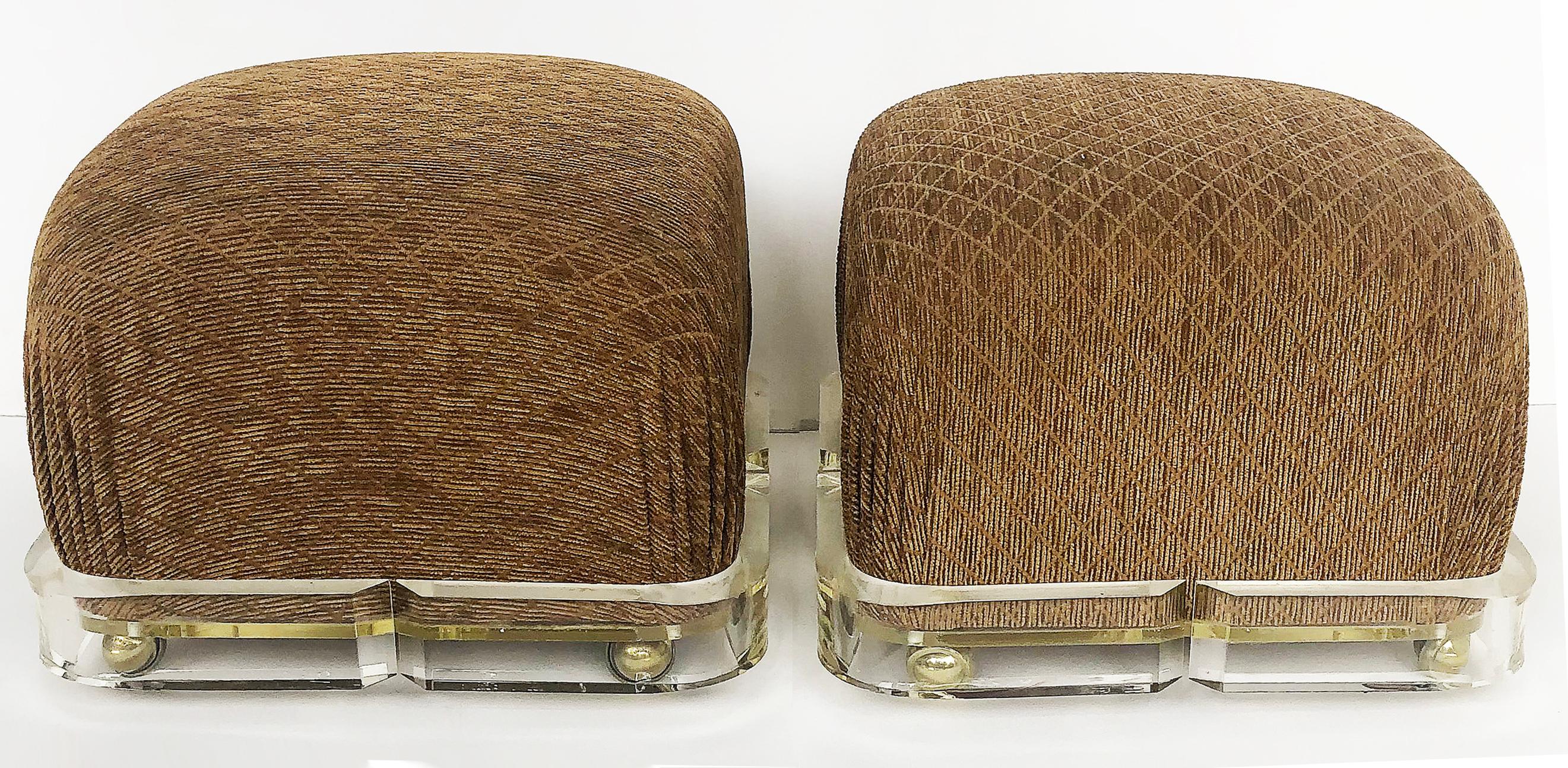 Karl Springer Upholstered Brass/ Lucite ottoman poufs, 1980s on Casters, a pair

Offered for sale is a wonderful pair of Karl Springer rolling poufs. The matching poufs are upholstered in a textured velvet which recesses into the Lucite rolling
