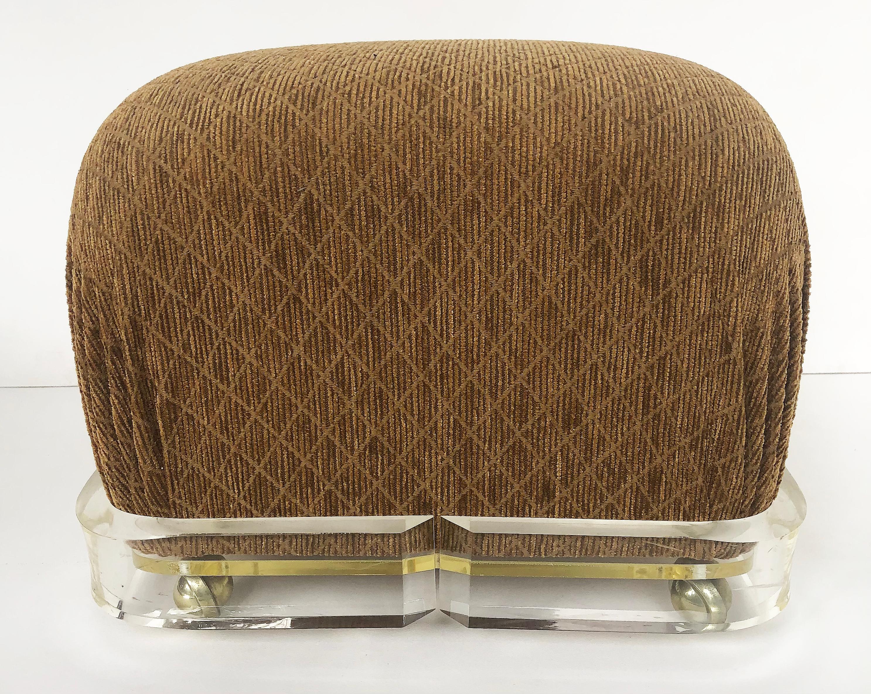Mid-Century Modern Karl Springer Upholstered Brass/ Lucite Ottoman Poufs, 1980s on Casters, a pair