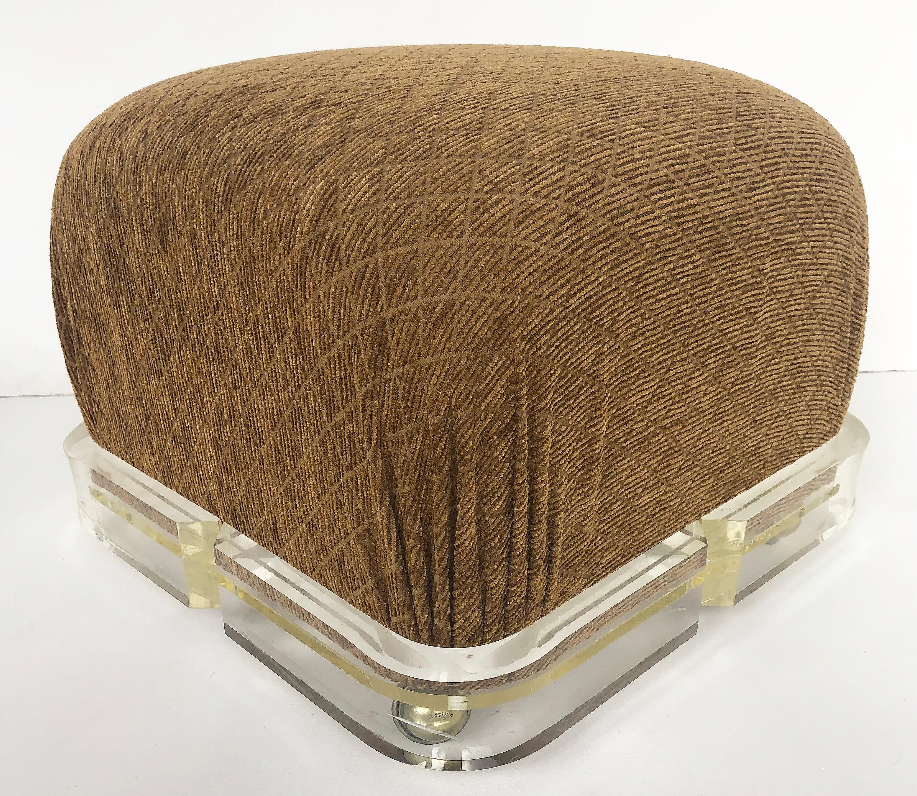 American Karl Springer Upholstered Brass/ Lucite Ottoman Poufs, 1980s on Casters, a pair