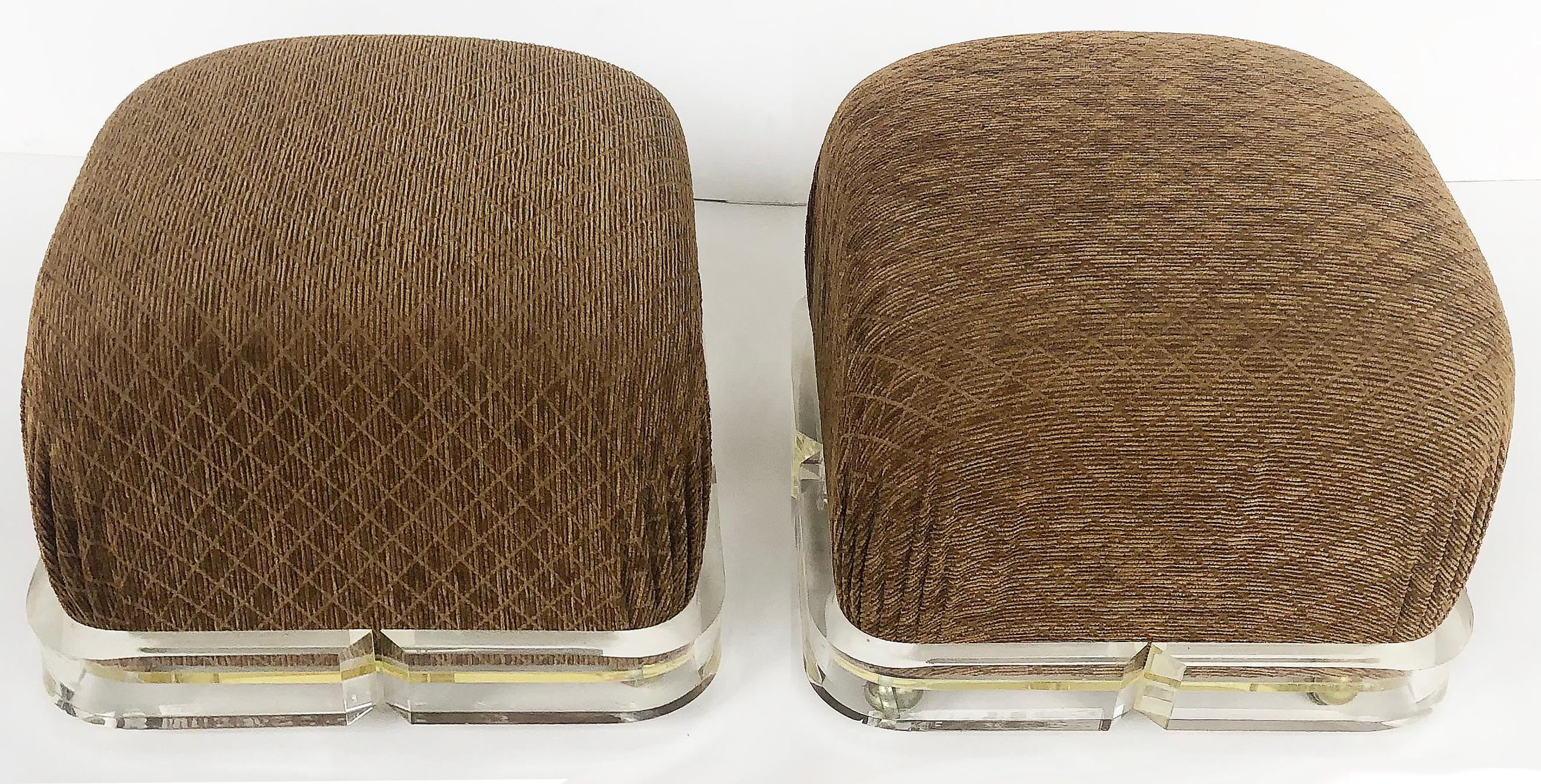 20th Century Karl Springer Upholstered Brass/ Lucite Ottoman Poufs, 1980s on Casters, a pair