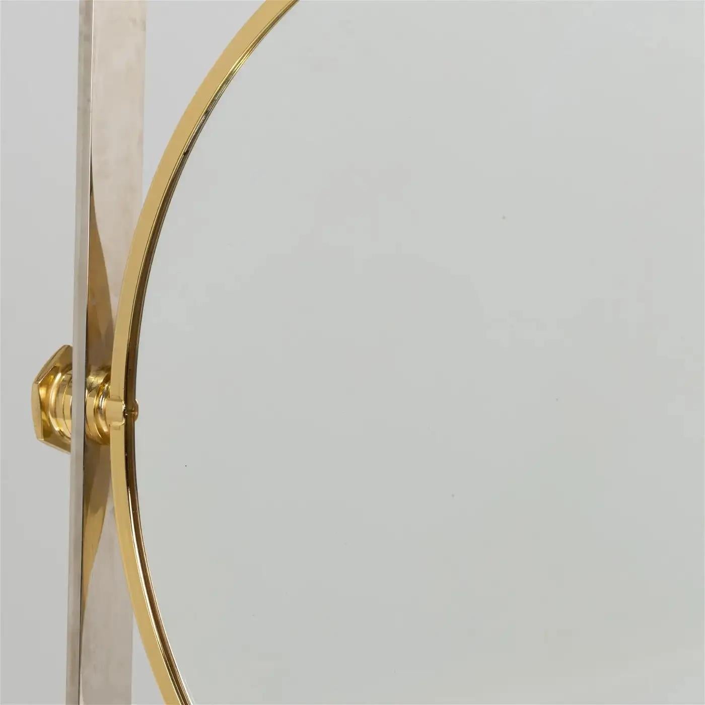 This stunning 1980s Karl Springer mirror embodies the designer’s iconic mix of luxury and function. One side features a classic circular mirror, while the reverse offers a convex, magnified mirror. Framed in polished steel and accented with brass,