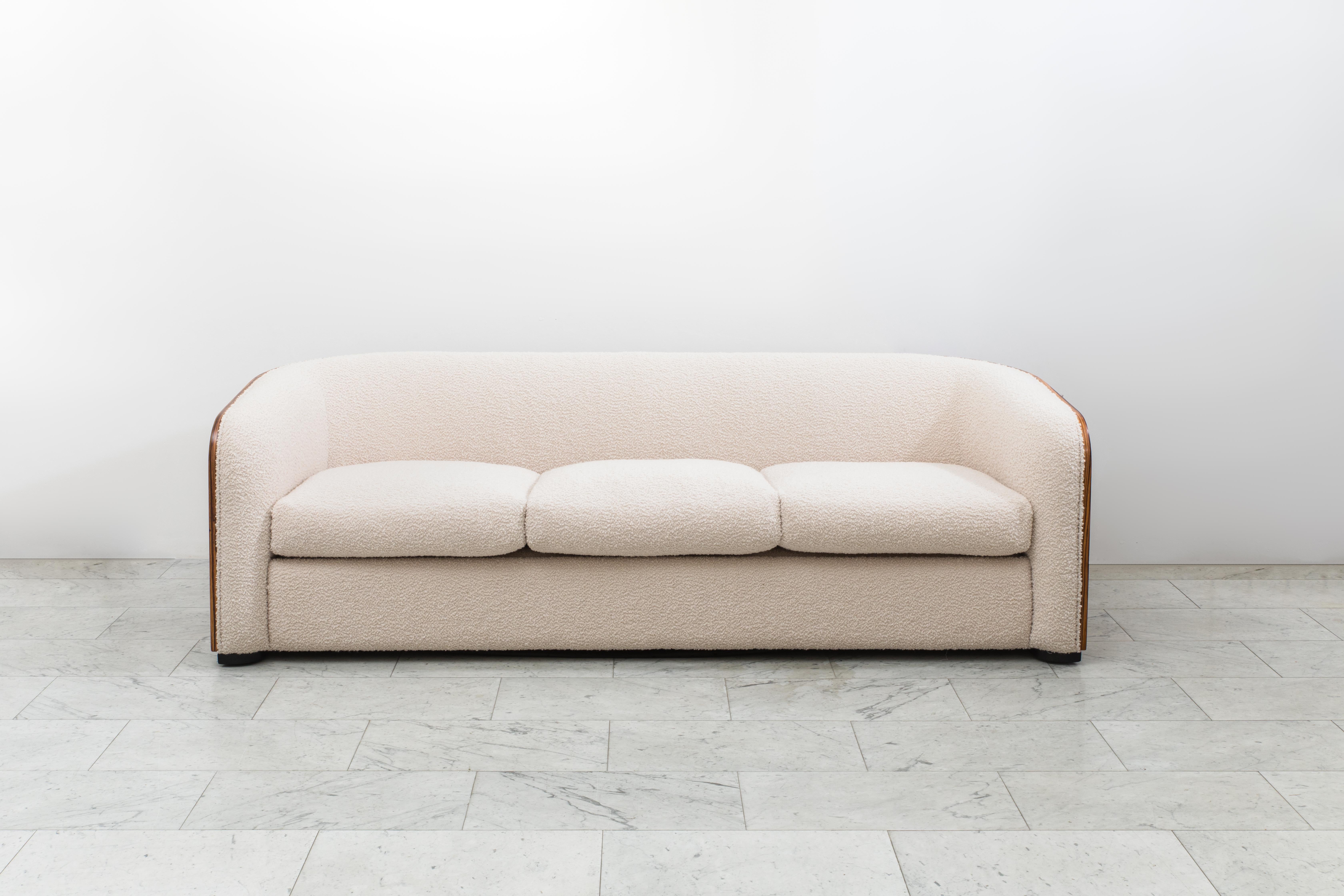 This one-of-a-kind, zebra-wood sofa from Karl Springer was a custom commission based on Springer’s popular “Pullman Sofa.” The Pullman Sofa features a wrap around, flat back that curves gently into armrests.  Its low profile and rich, book-matched