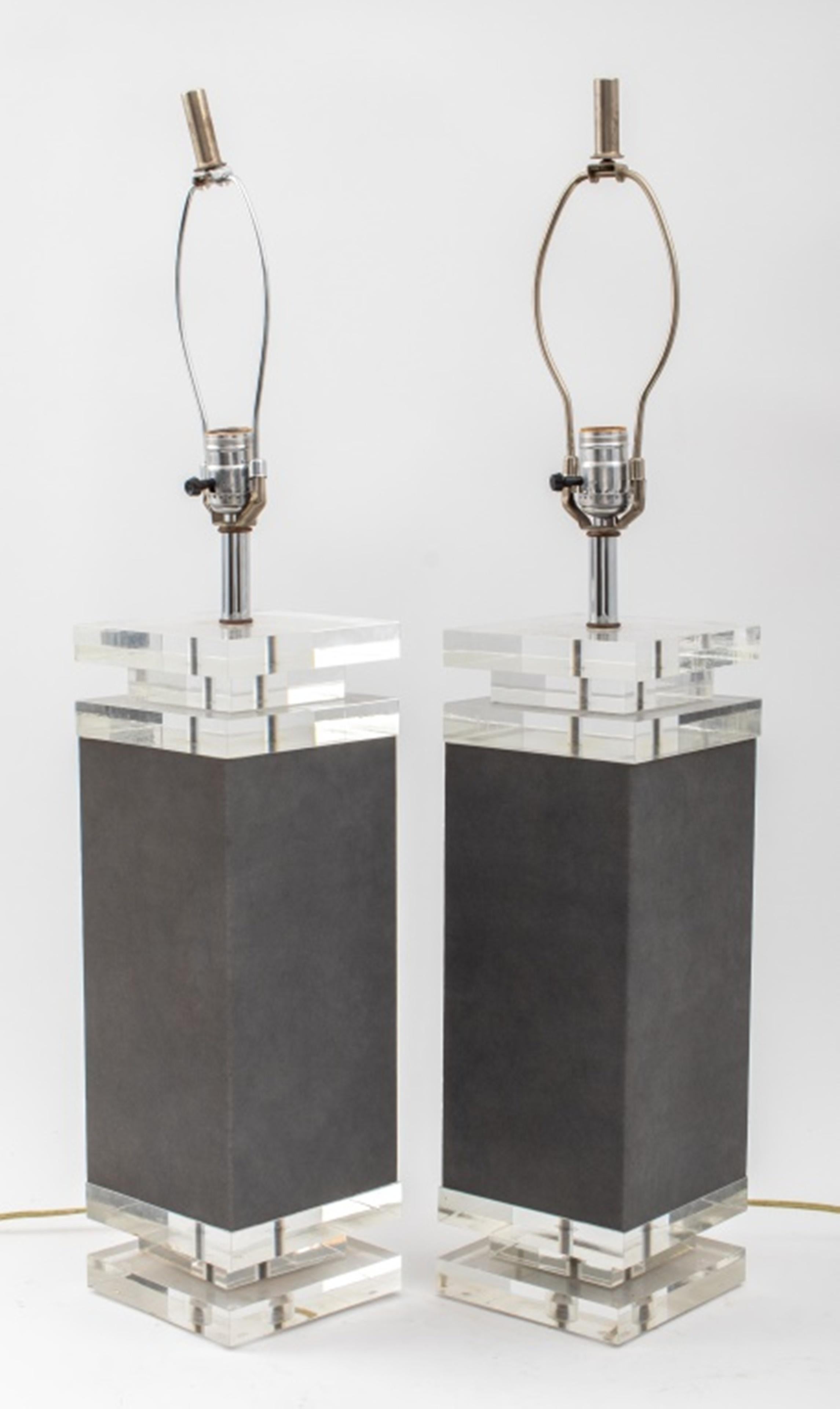 Karl Springer (German-American, 1931 - 1991) pair of modern square base table lamps enveloped in gray textured laminate with stacked Lucite elements, circa 1980s. Measures: 23