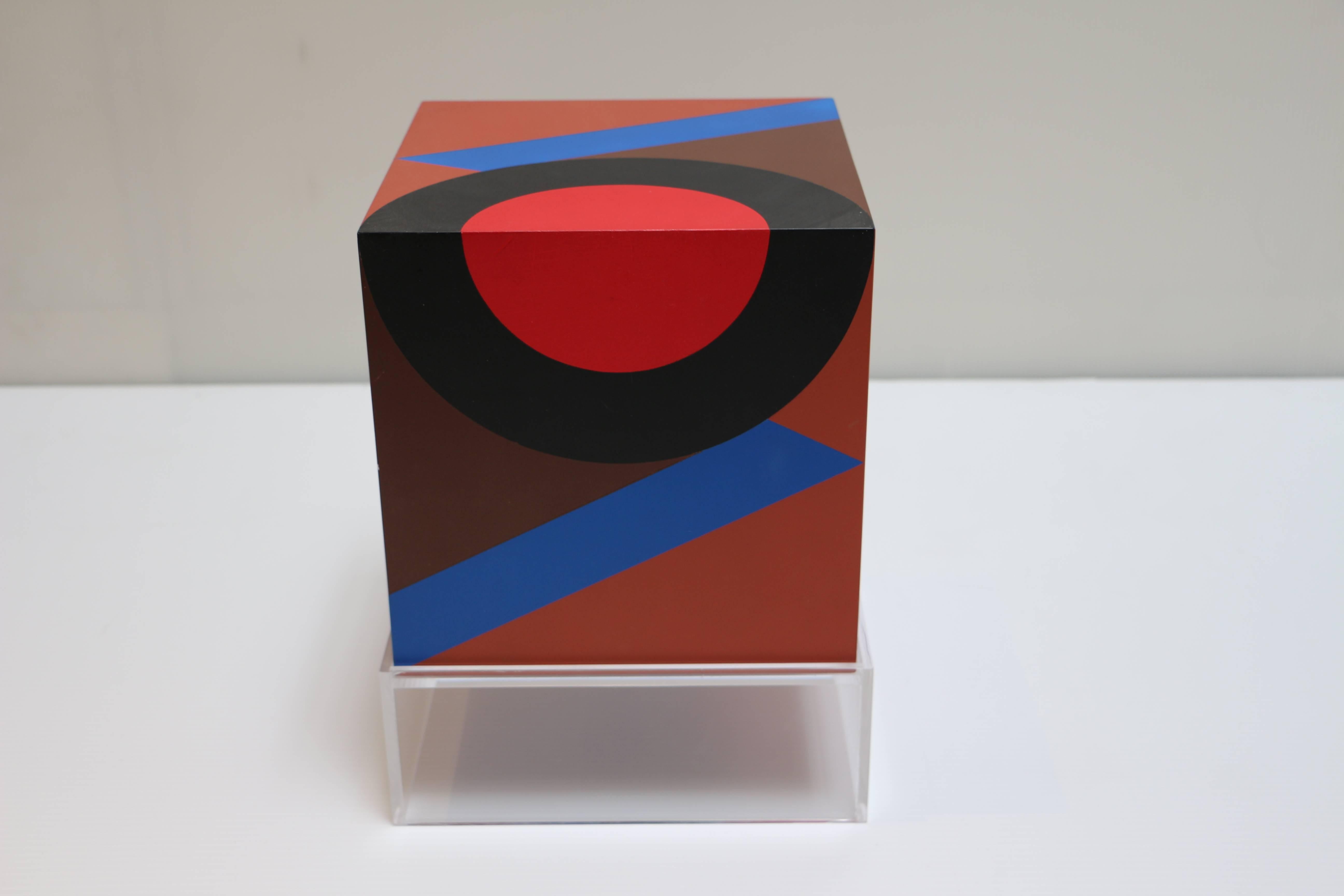 This original artwork by Karl Benjamin (1925–2012) is comprised of a wood cube structure with oil paintings on fives surfaces. 

Benjamin was known for filling his prints with orchestrated colors, and for his sensitivity to the union of form and
