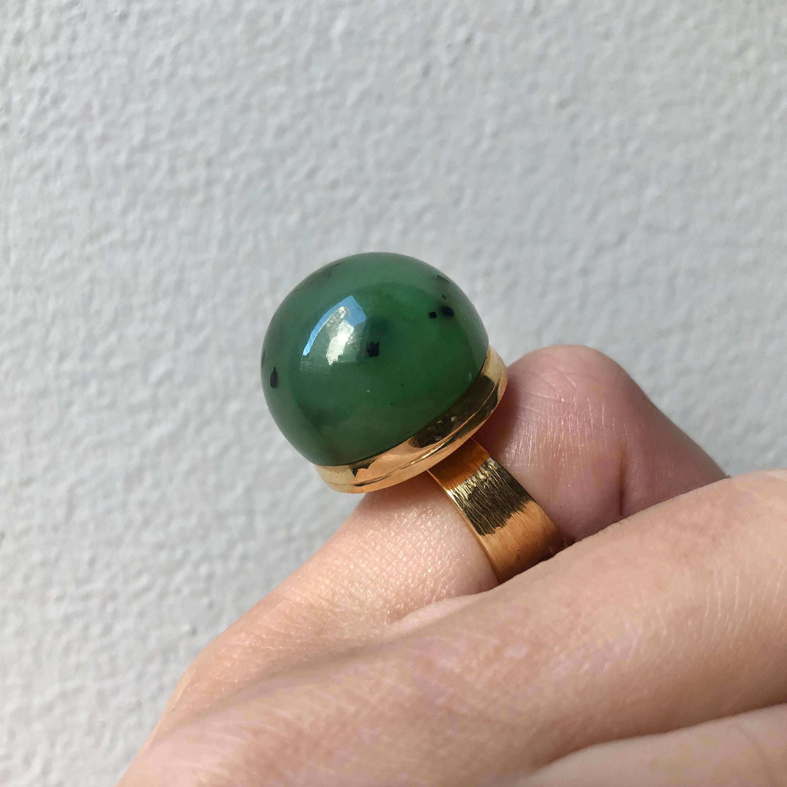 A cabochon nephrite and yellow 18 karat gold ring, by Canadian maker Karl Stittgen. Stamped with maker's mark for Karl Stittgen and 18k.
Size 4.5. This ring can be resized. 
Karl Stittgen was born in Ludwigshafen, Germany in 1930 and moved to