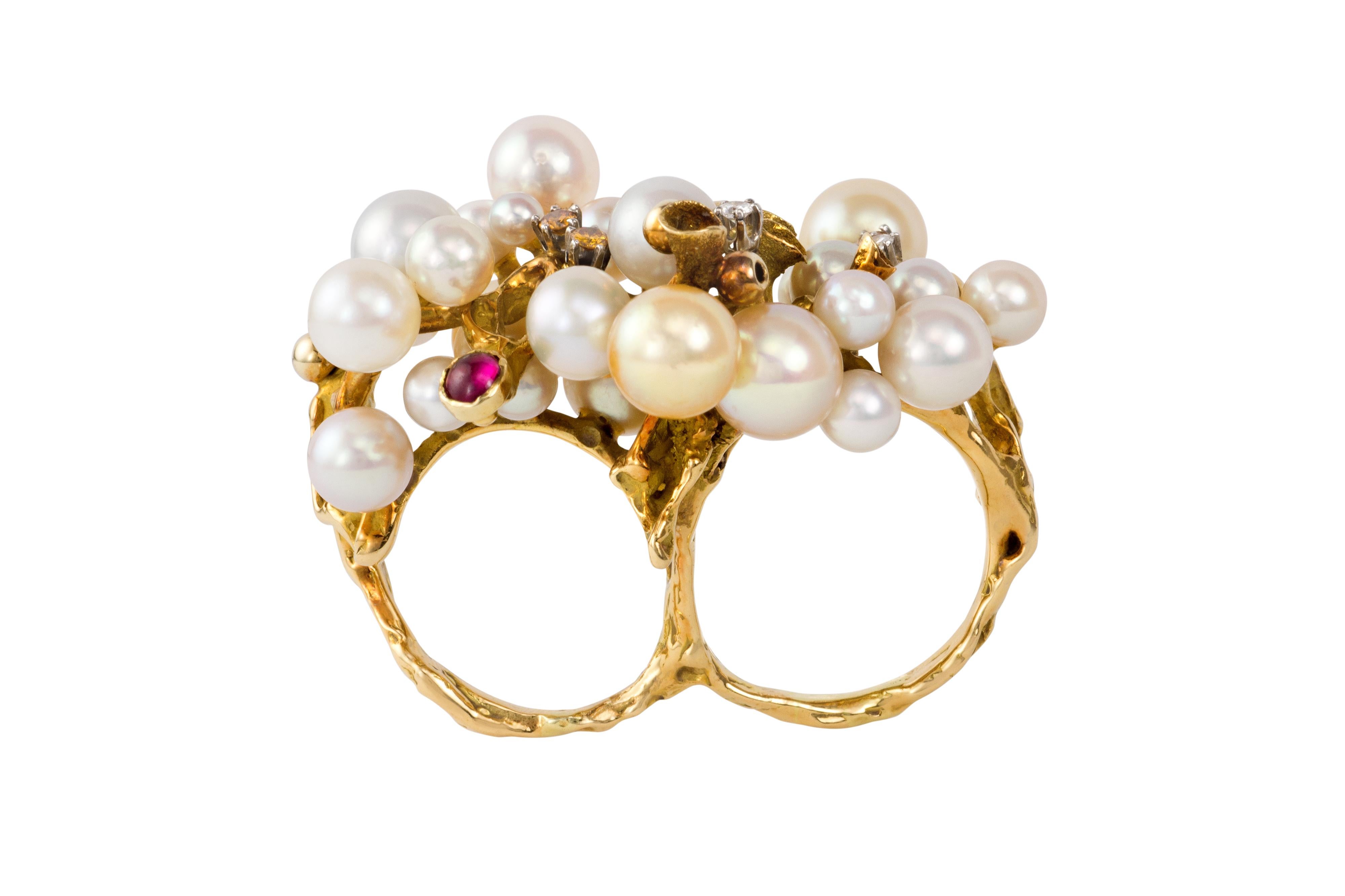 A pearl, ruby, diamond and 18 karat gold two-finger ring, attributed to internationally renowned artist jeweler Karl Stittgen, Canada. The ring measures 1.5