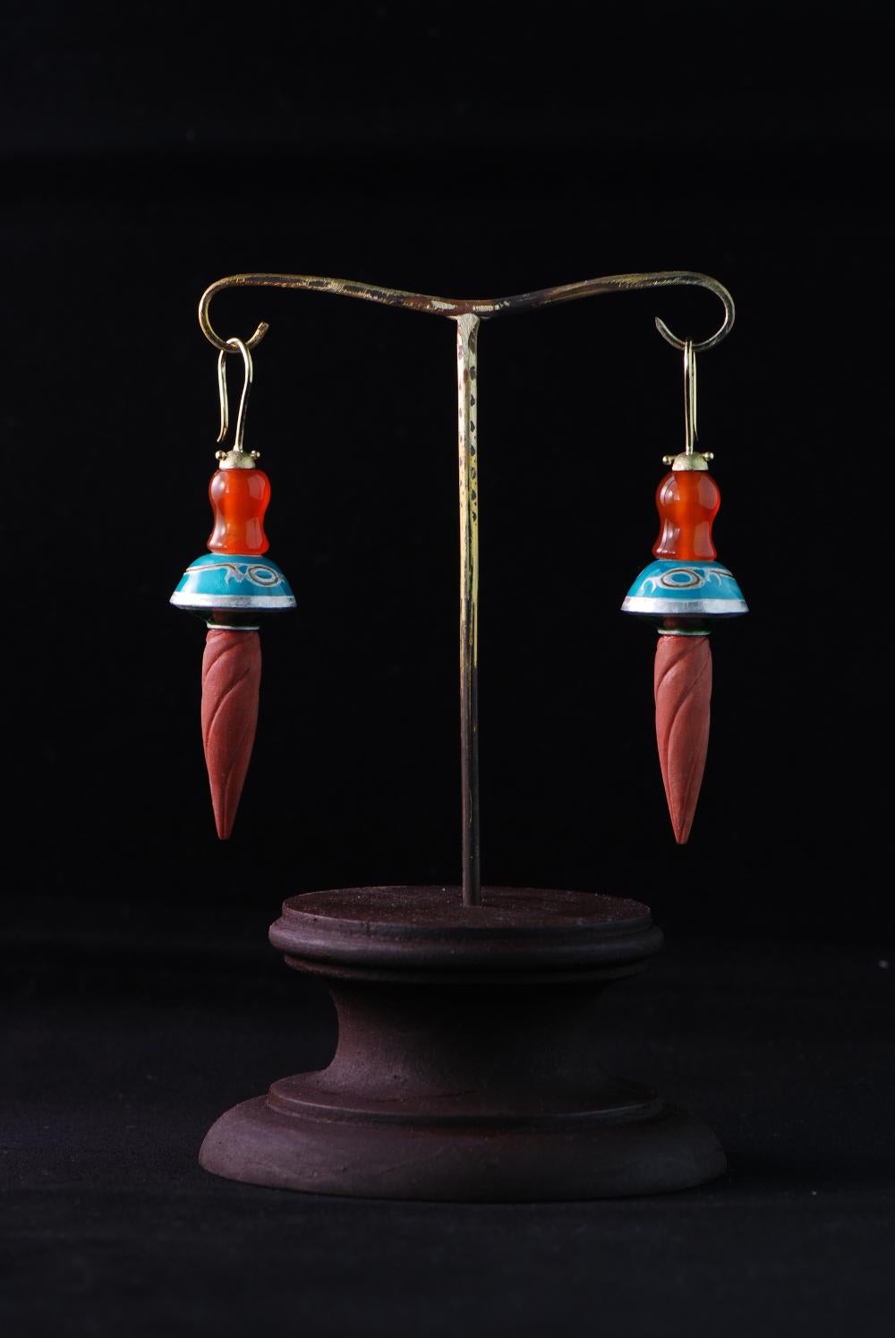 Earrings by Karl Wunderlich made of 18 ct yellow gold, silver, carnelian pearls, wood and enamel.
With individual jewellery box and certificate. 
One of a kind. 
About the artist:
As a sculptor Karl Wunderlich explores the potentials and inherent