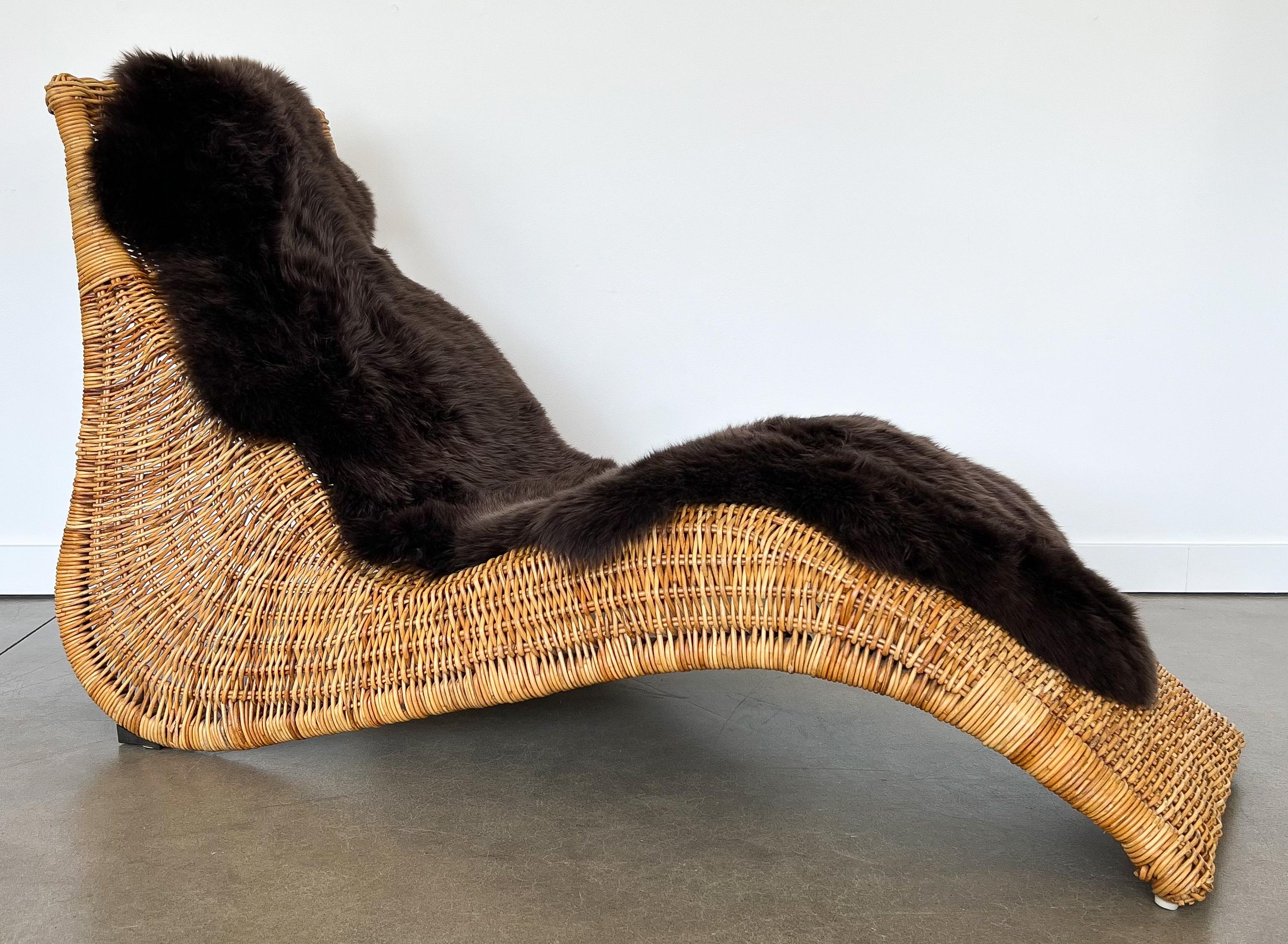Karlskrona rattan wicker chaise lounge chair by Karl Malmvall for Ikea, Sweden circa 1990s. The Karlskrona chaise features a sculptural, organic undulating form in woven wicker and bent rattan / bamboo. Plastic glides at front and angled metal