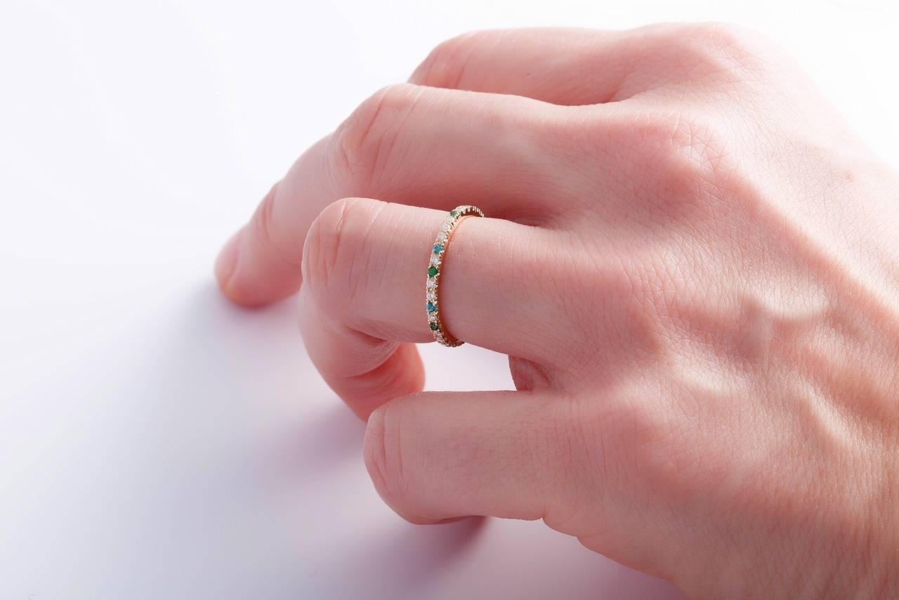 This ring called Lana is the perfect mix between a classic wedding ring and a cute ring to stack with your other rings.
Set in 18 k rose gold and 0,24 ct diamonds and natural green and blue topaz.