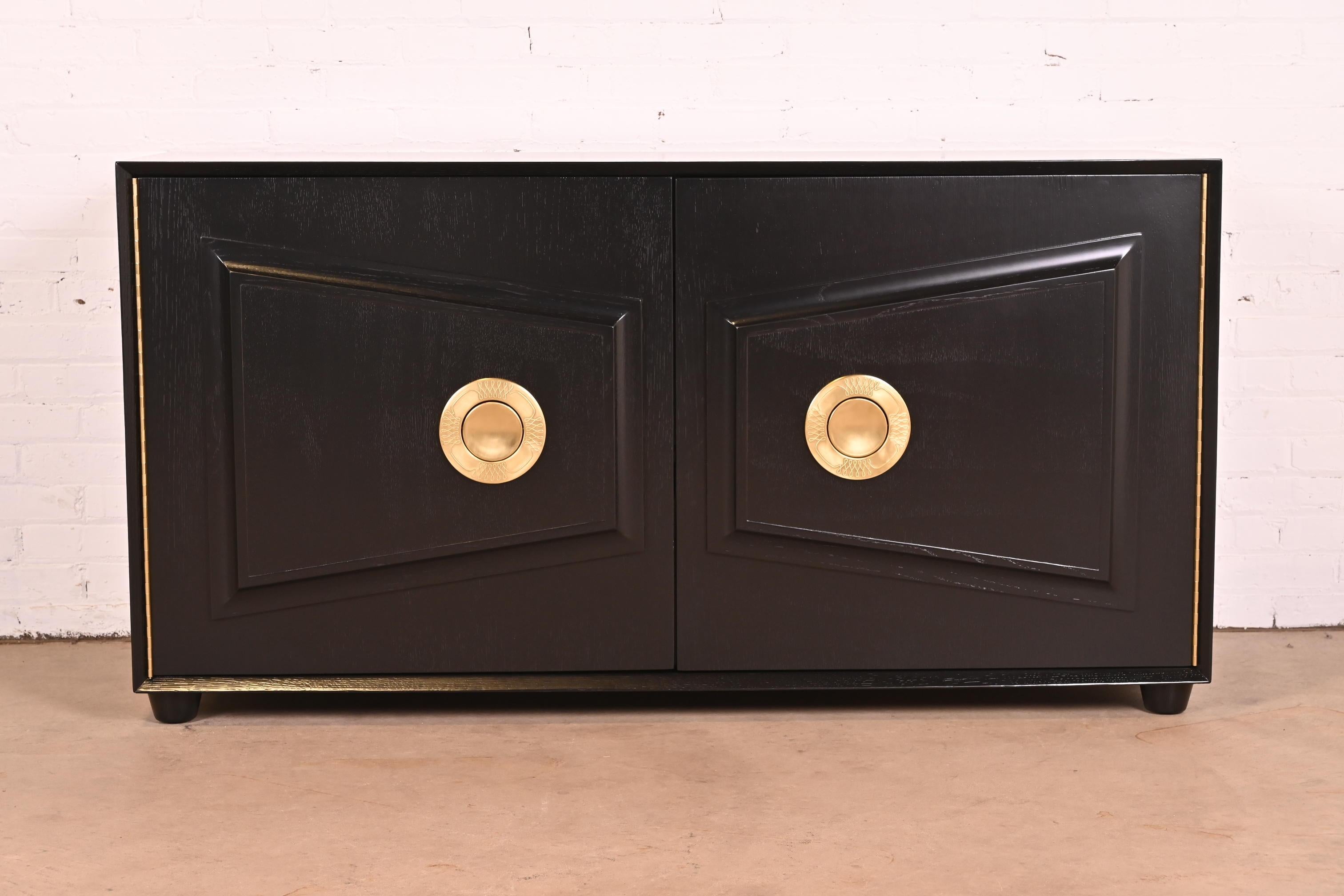 An exceptional Mid-Century Modern Hollywood Regency sideboard, credenza, or bar cabinet

By Karpen of California

USA, 1950s

Black lacquered walnut, with unique original brass hardware.

Measures: 62