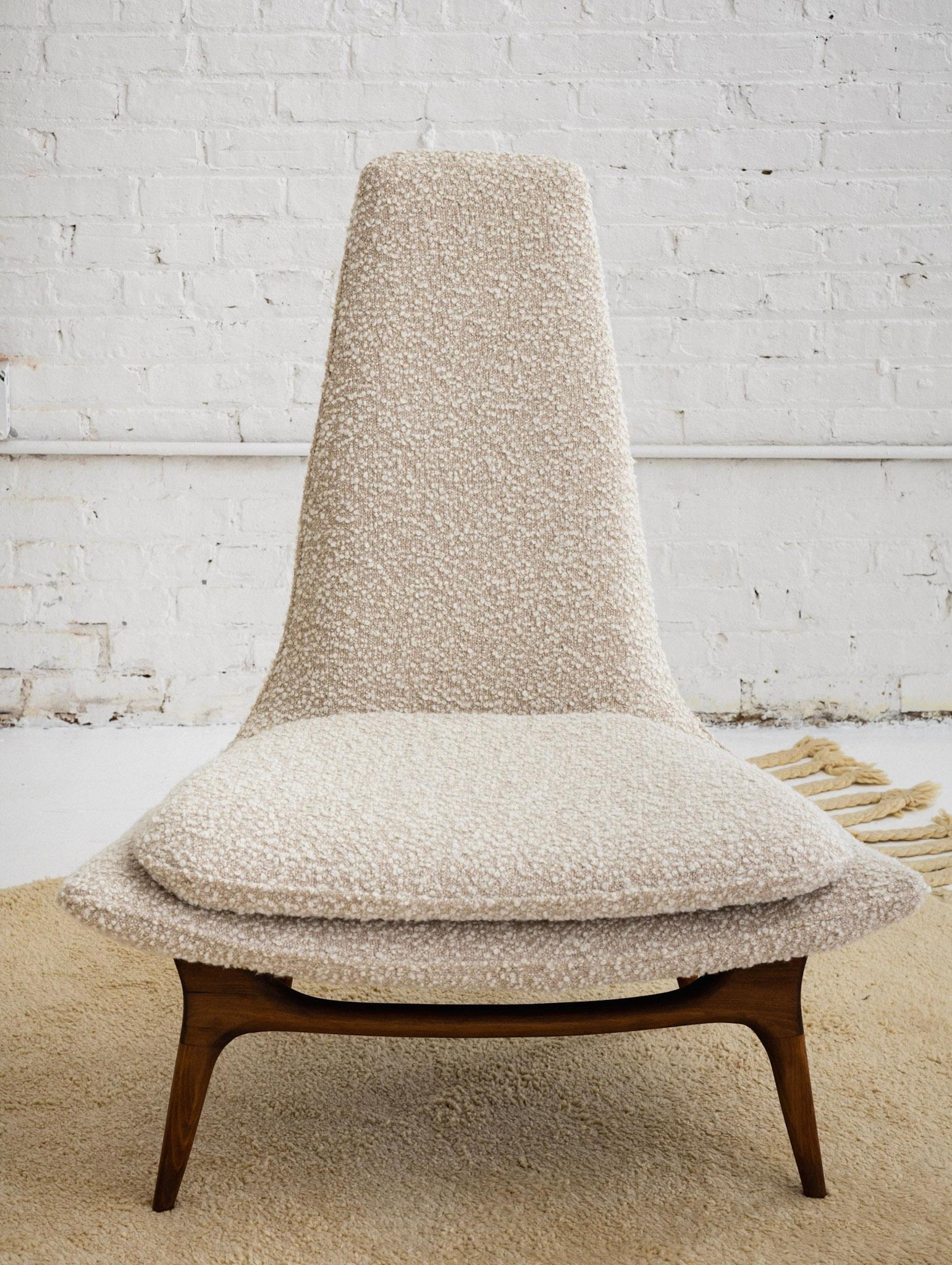 A mid century slipper lounge chair attributed to Karpen of California. Handkerchief silhouette. Newly restored walnut feet. New cream and beige high quality wool bouclé upholstery.