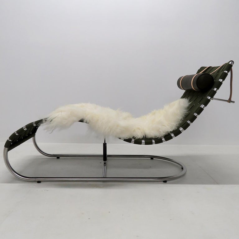 Stunning chaise longue Modell GD1 designed by Karsten Gransgaard for Gransgaard Design with green furniture webbing on a chrome plated steel frame, neck pillow in 'Vacona' aniline leather and a sheep skin. The seating position can be adjusted by a