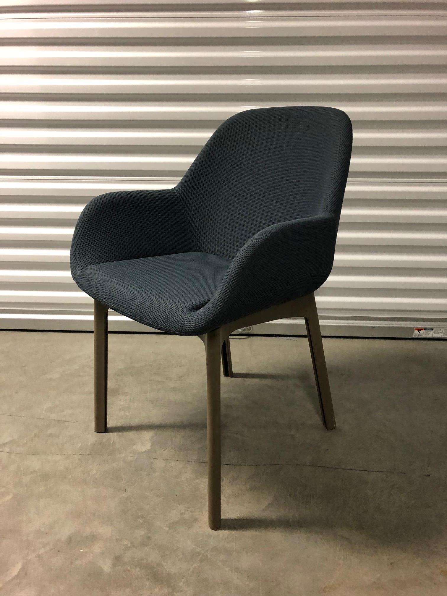 Kartell Clap chair designed by Patricia Urquiola. The armchair bearing the was specially designed for the contract sector and to extend Kartell’s Soft line. Tortoise colored technopolymer legs with dark gray solid colored Trevira upholstery.