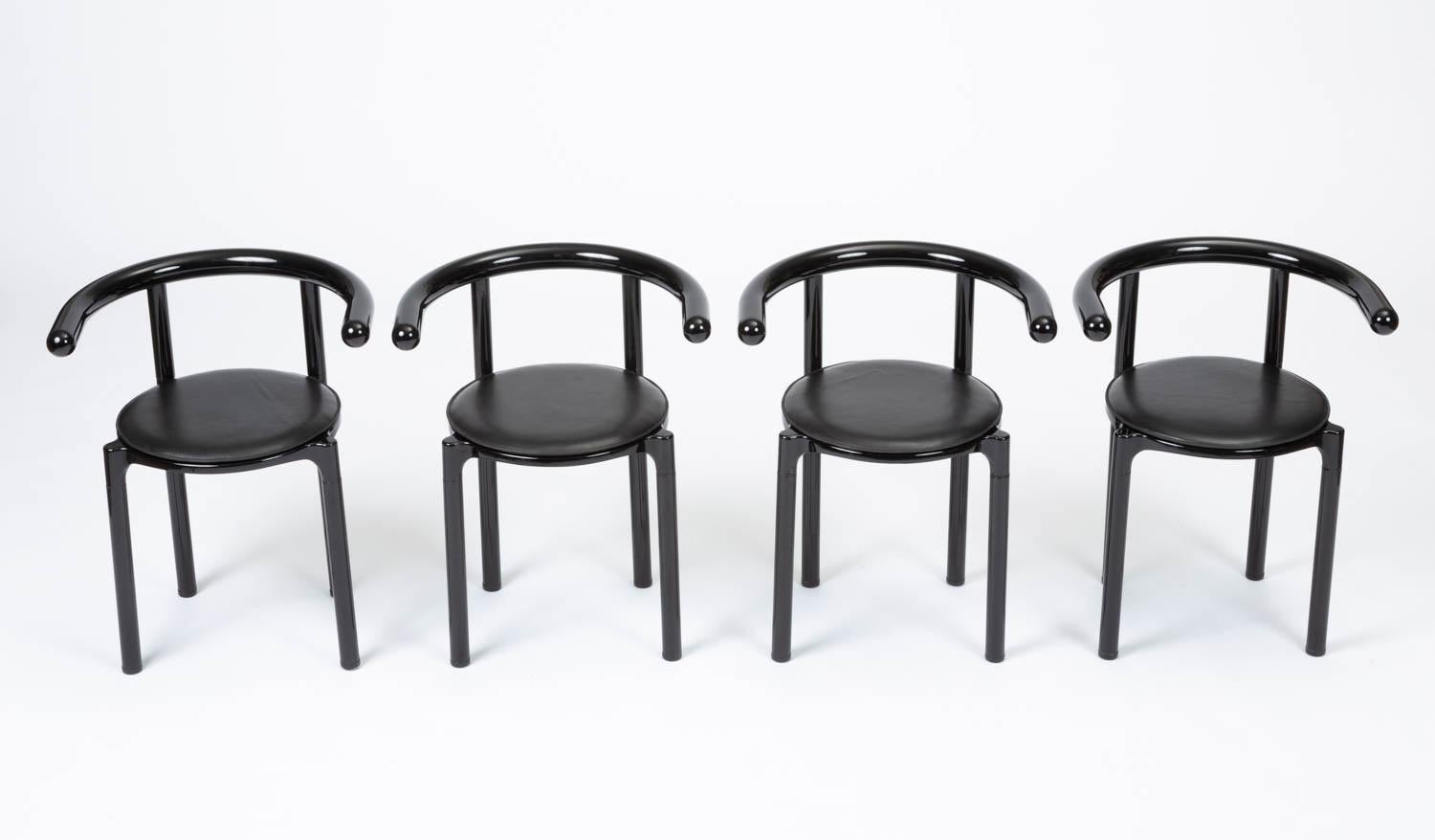 A set of four late modernist dining chairs from Italian design house Kartell. The 4855 model is a rarer edition of seating, designed in 1981 by the company’s co-founder and Art Director, Anna Castelli Ferrieri. Each chair has a round leather seat on