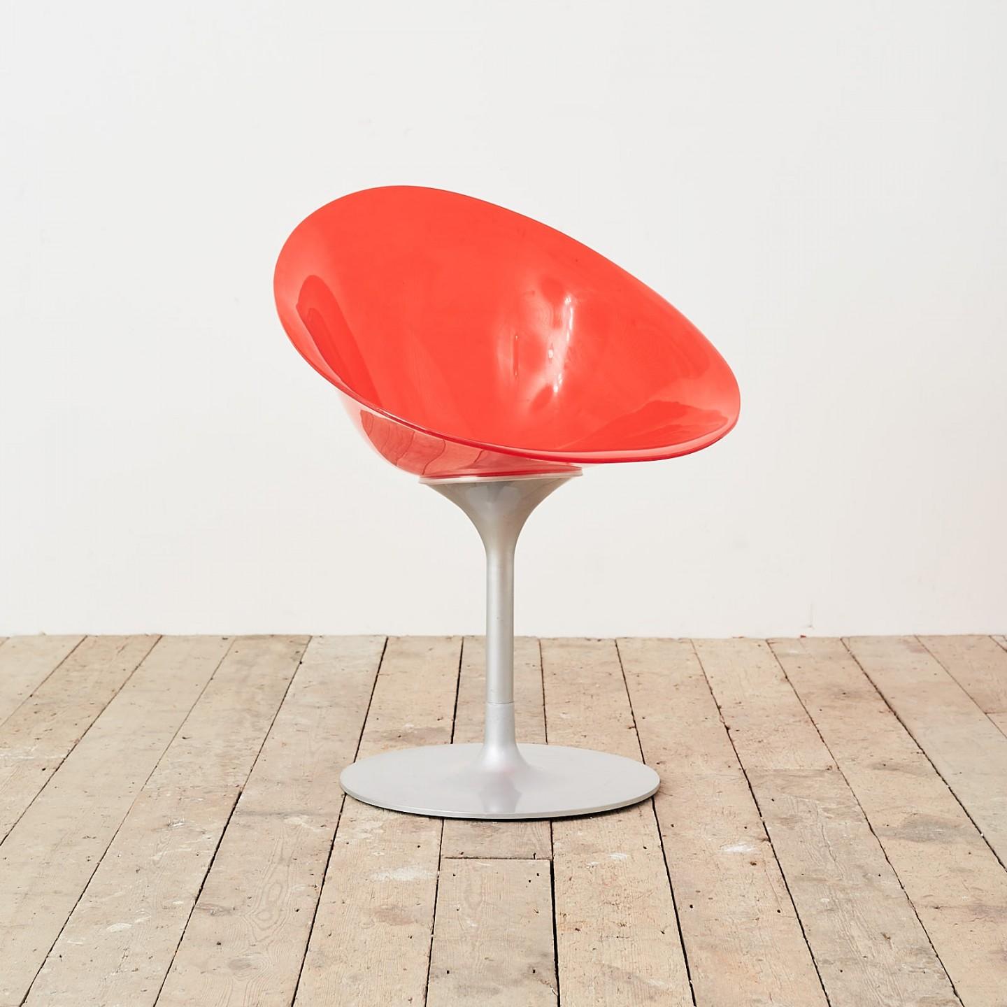 A Kartell Eros chair by Philippe Starck. Red Lucite with swivel base.
