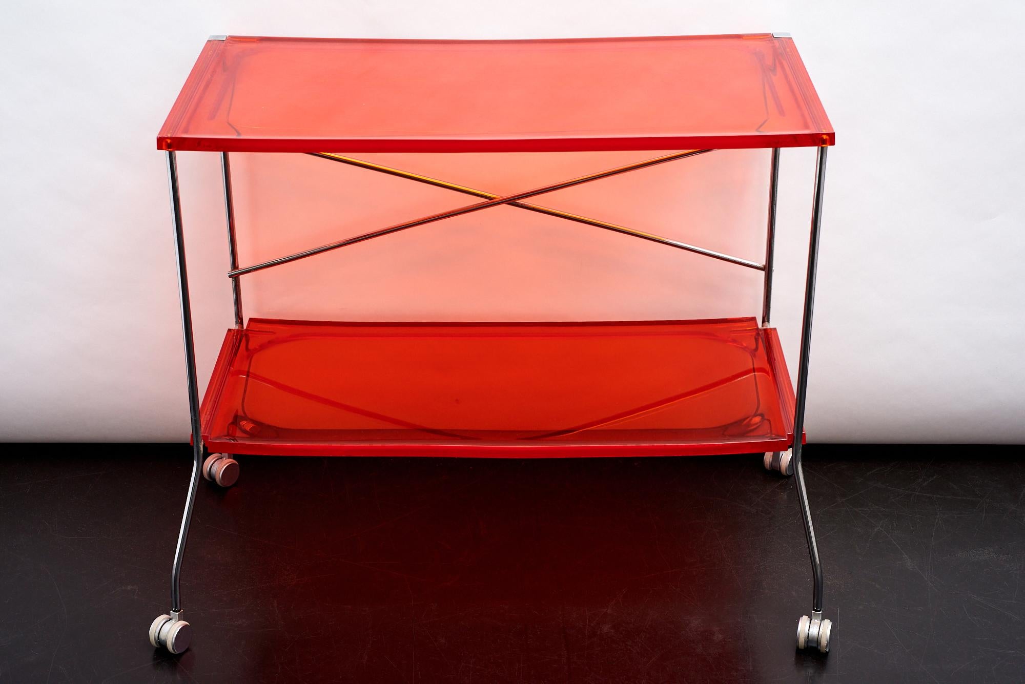 Flip folding trolley by Antonio Citterio for Kartell in shocking orange.
The plans, independent of each other, are from PMMA lenticular sheet and offer extreme multi functionality and aesthetics. Flip can be used as a cute little desk, or as a