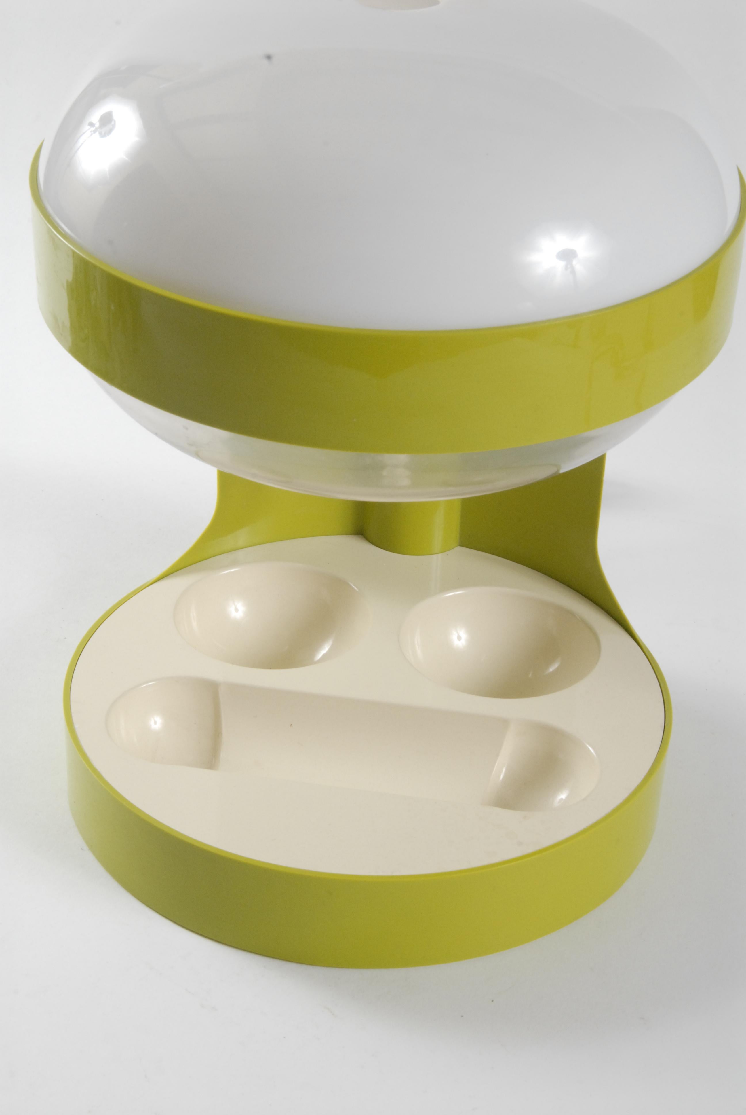 Classic space age designed green table lamp by Joe Colombo for Kartell and licensed manufacture by Advance Industries Australia.

The KD29 table lamp is made entirely of plastic and has a tray for pens and small office equipment.
The top diffuser