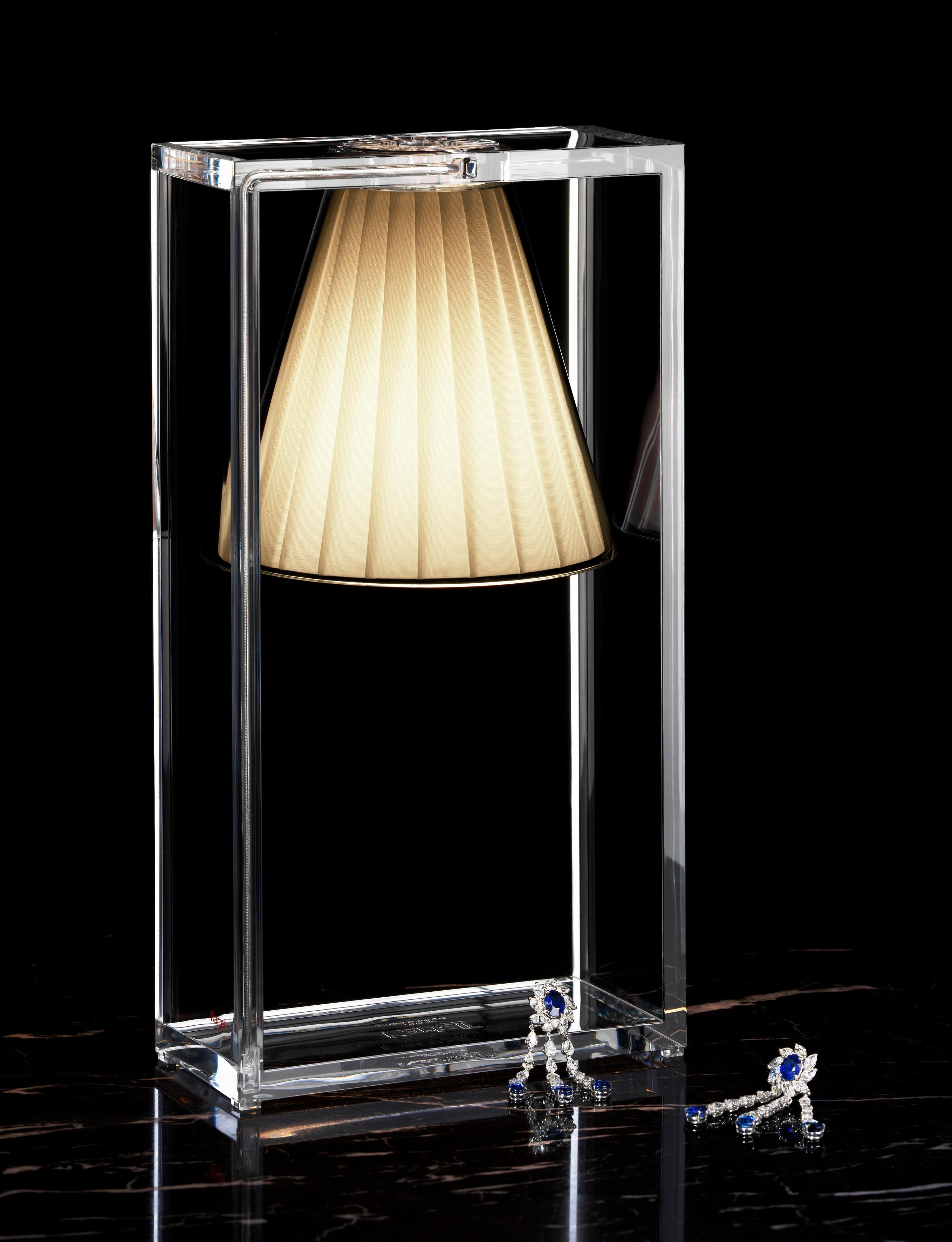 An illusionist table lamp, a suspended light that eludes the laws of gravity. Light-air is essential, modern and rational, but at the same time it produces a magic effect. Its structure is a strong graphic statement composed of a rectangular frame