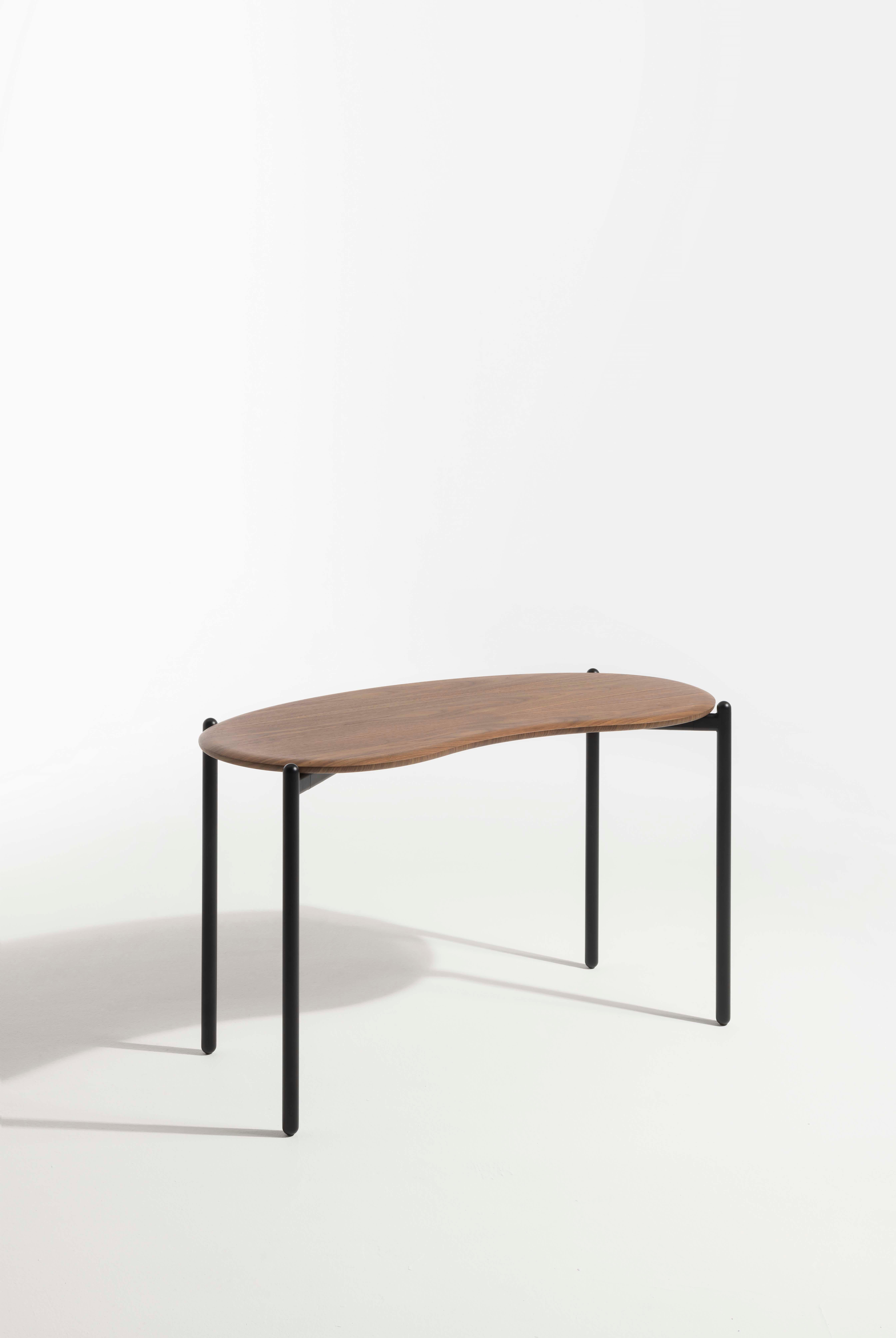 The LUNAT desk, designed by Patricia Urquiola, creates the ideal solution for a home smart working station as well as a desk in a hotel room. The powder-coated legs grow slender up to the bean-shaped top; the top is available in flamed walnut finish.