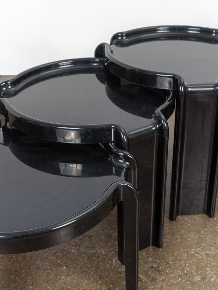 Compact set of three nesting tables by Giotto Stoppino for Kartell. Playful design made of ink black injection-molded ABS plastic. Age-appropriate wear to the surface with no cracks. All tables are stamped on the underside. Italy,
