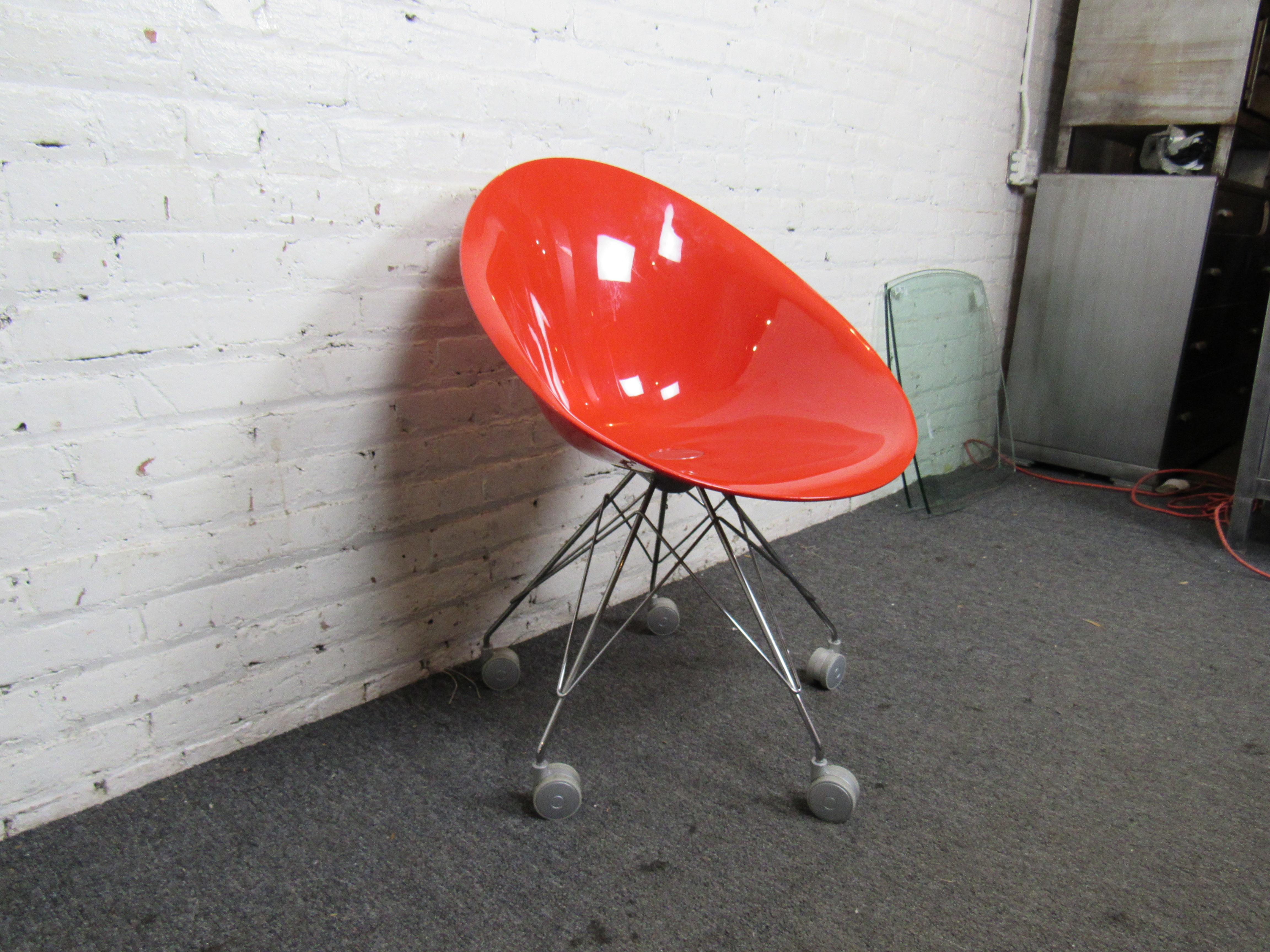 Classic Mid-Century Modern rolling chair in a bold cherry red. Designed by the famed Parisian Philippe Starck for Italy's Kartell Furniture. Five swivel wheels are sure to move all who see it.  (Please confirm item location - NY or NJ - with