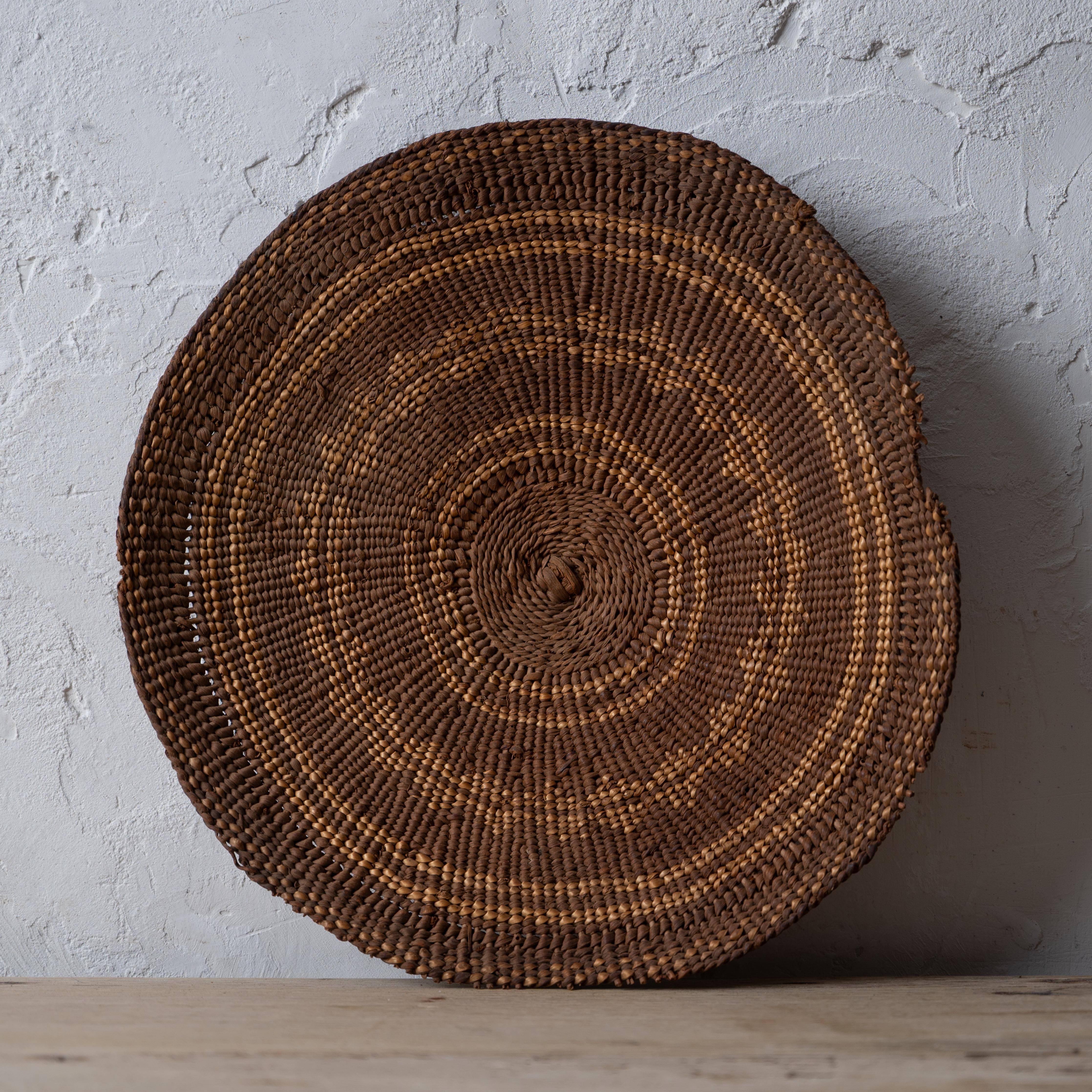 A Karuk winnowing tray basket, circa 1900.

11 ¾ by 11 ¼ inches; 2 inches deep

