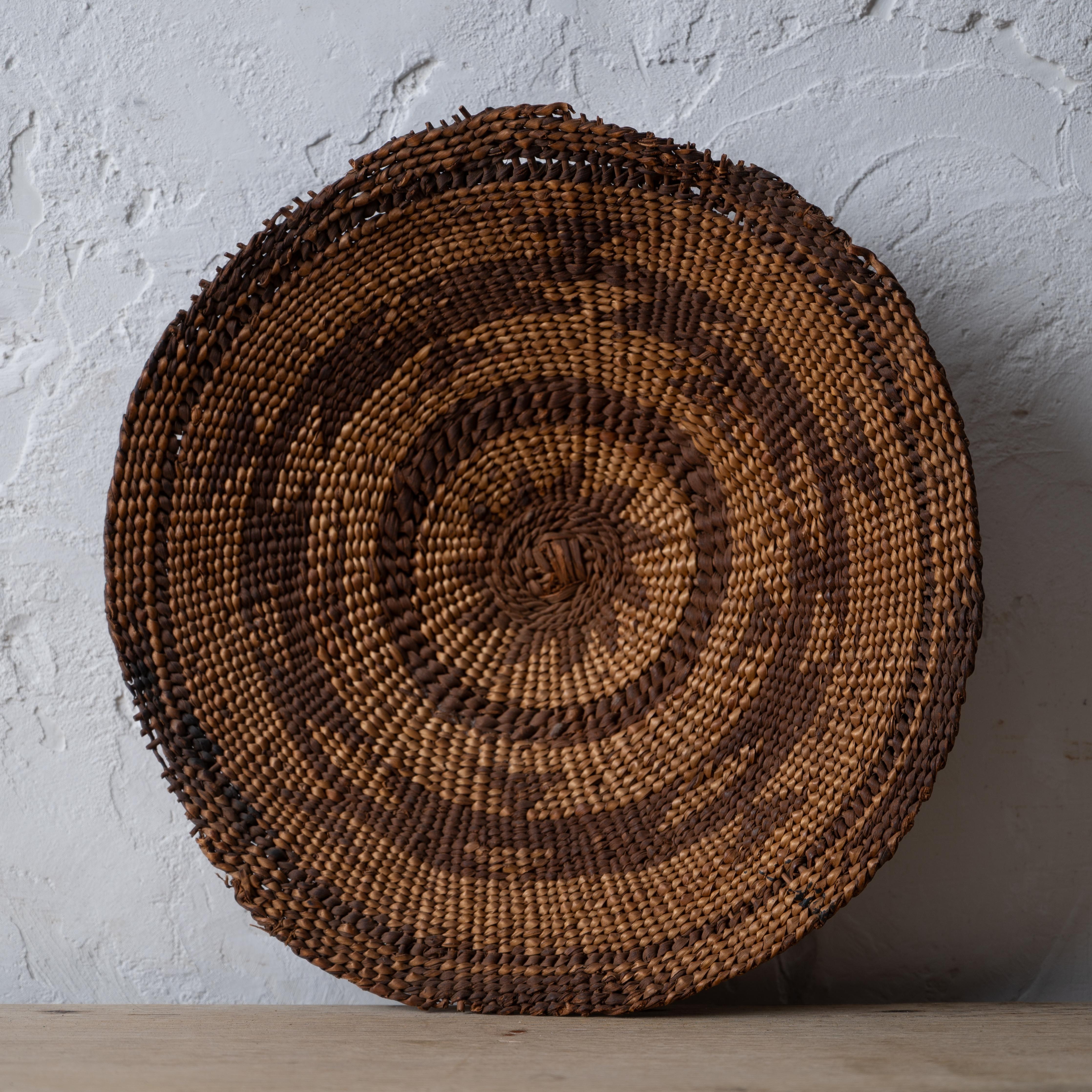 A Karuk winnowing tray basket, circa 1900.

11 ¼ by 11 inches; 2 inches deep 



