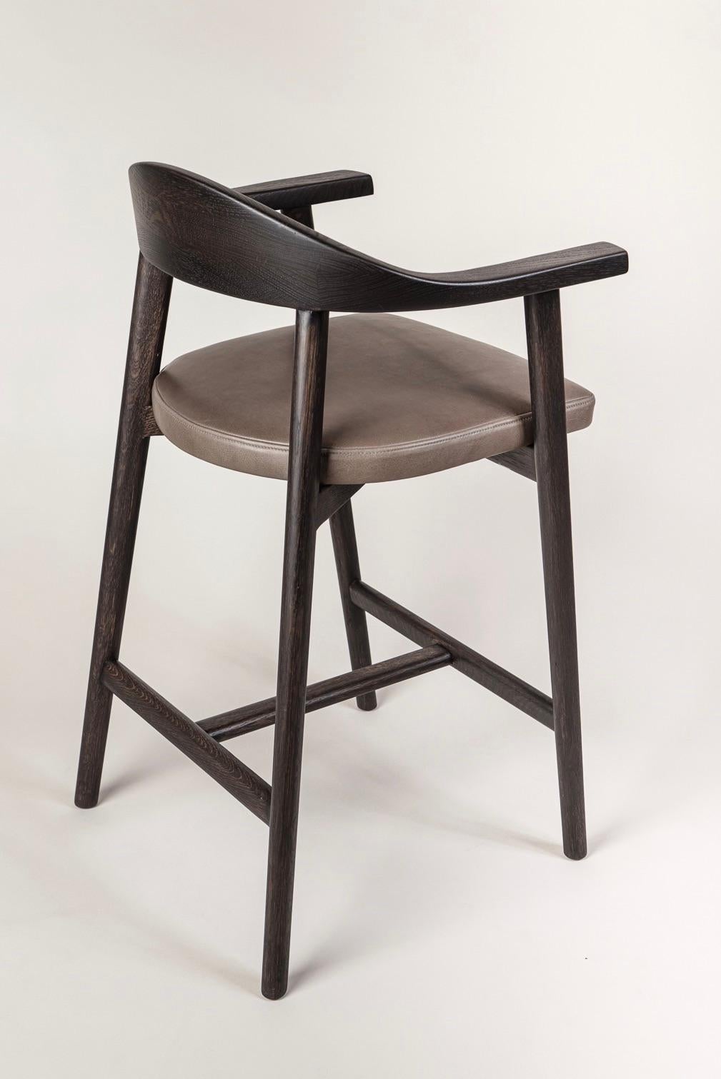 Karve counter stool shown in a dark Wenge Stained White Oak & natural grain, smooth finish leather upholstery. A classic design, elegant yet sturdy in form, handcrafted to last generations. 

Bespoke options always available. Wood species include