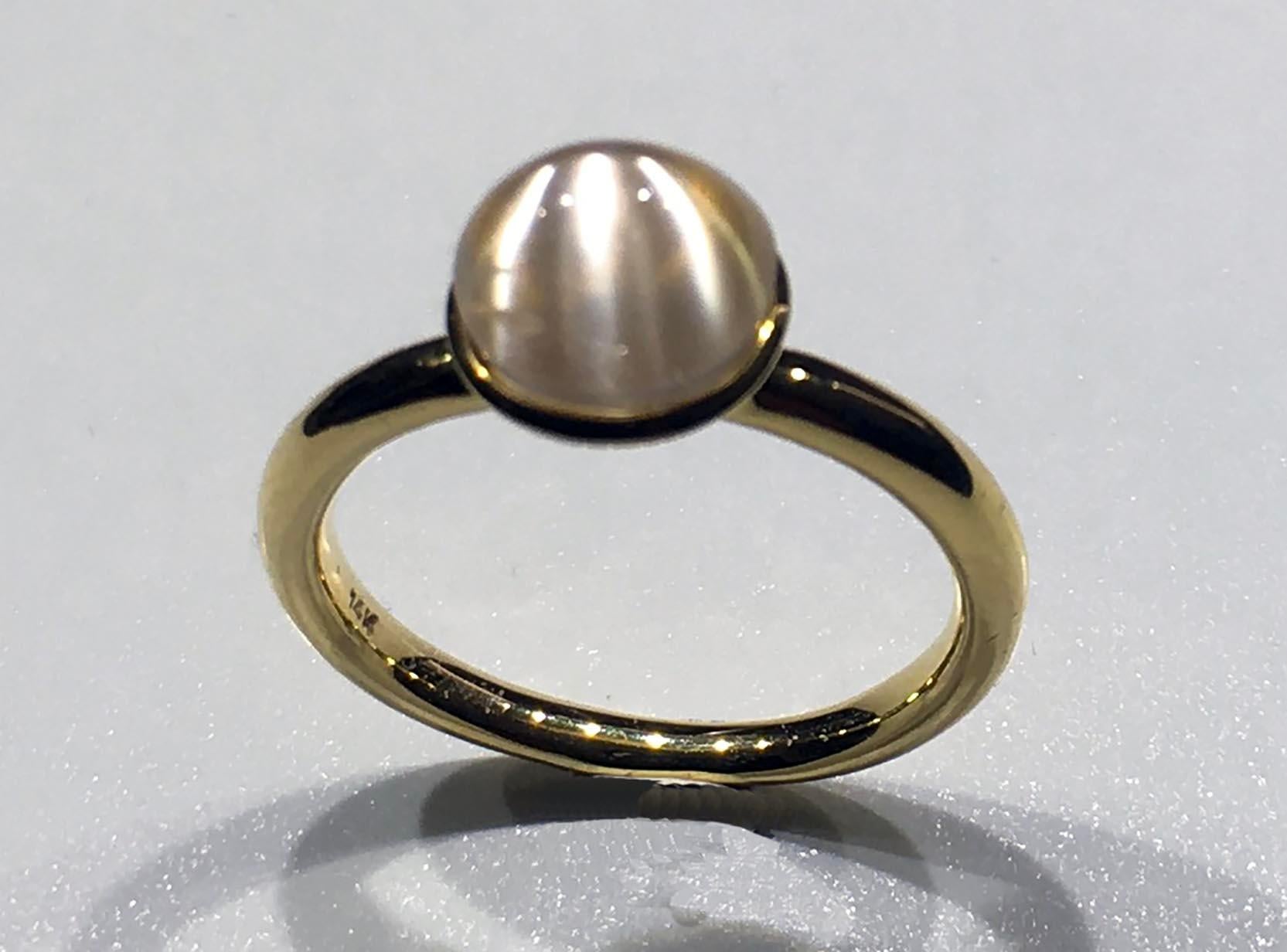 Kary Adam Designed, Burmese Moonstone Ring set in 14kt Gold. This Lovely Burmese Moonstone Ring is in 14kt Gold and sized at 6.5 US. The Moonstone is a large 7MM Cabochon of 2.7 Carats. 

The moonstone effect is called Adularescence. Adularescence