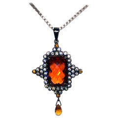 A Checkerboard cut Orange Sapphire Pendant Set in Blackened Silver