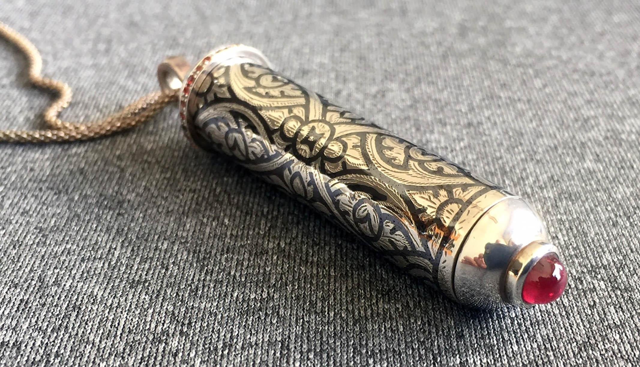 This Lanna Style Pendant was created in a traditional Thai craft style called Nielloware. Using an amalgam of Tin Oxide inlayed on a Silver setting displays a beautiful design contrast of Silver and dark Tin Oxide.  The Pendant is hollow with a
