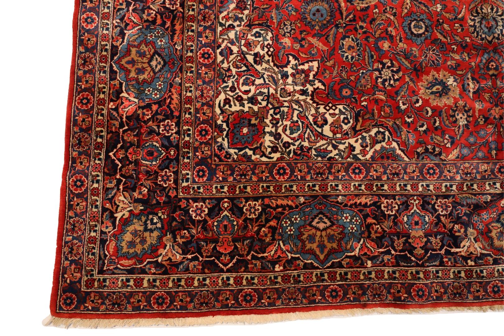 Indulge your senses in the luxurious embrace of a Kashan room-size rug, a true masterpiece that invites you to uncover its mesmerizing intricacies. This opulent textile treasure unfolds before your eyes, revealing a harmonious interplay of vivid